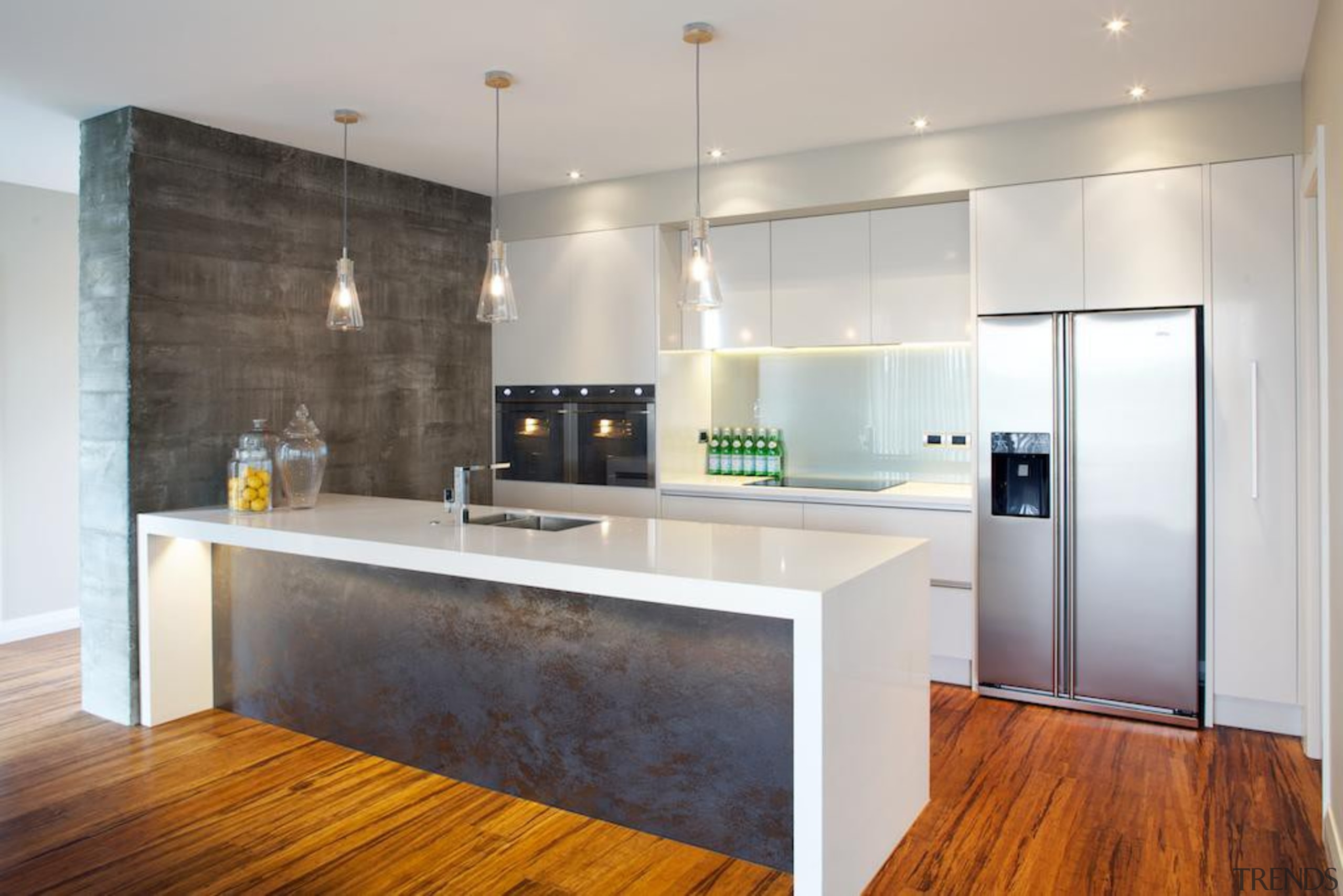 This industrial style kitchen makes use of a cabinetry, countertop, floor, flooring, interior design, kitchen, real estate, room, wood flooring, gray