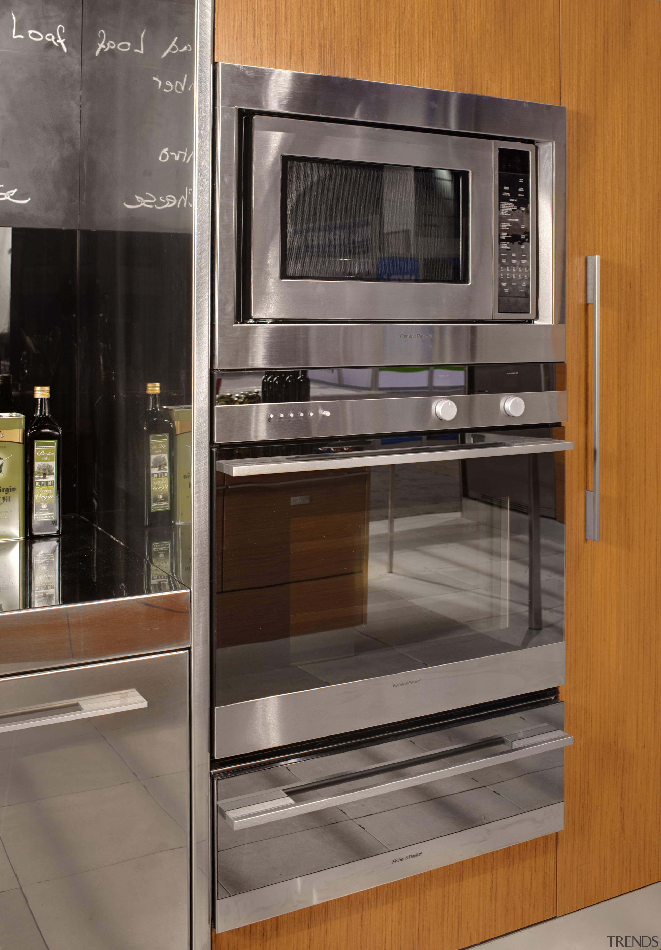 View of a kitchen which features DCS oven countertop, home appliance, kitchen, kitchen appliance, kitchen stove, major appliance, microwave oven, oven, gray, brown