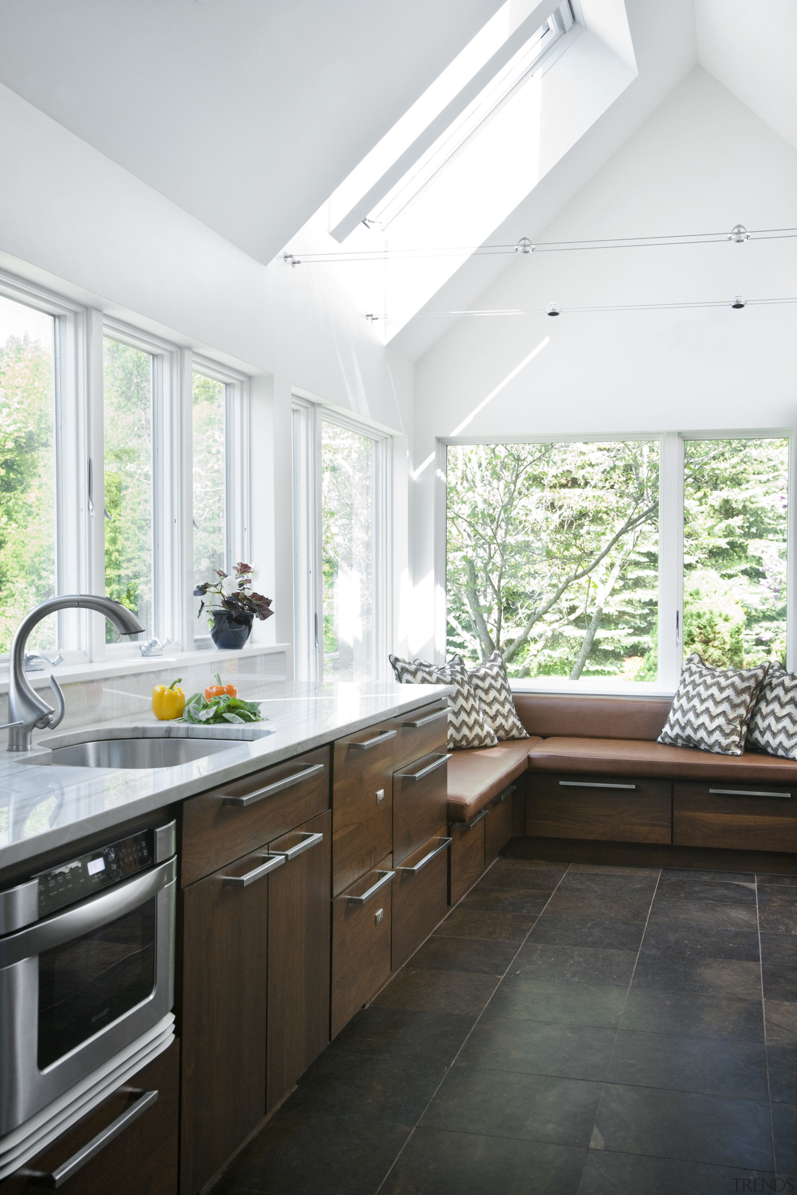 View of a kitchen which features white quartzite cabinetry, ceiling, countertop, cuisine classique, daylighting, floor, home, house, interior design, kitchen, real estate, room, window, white