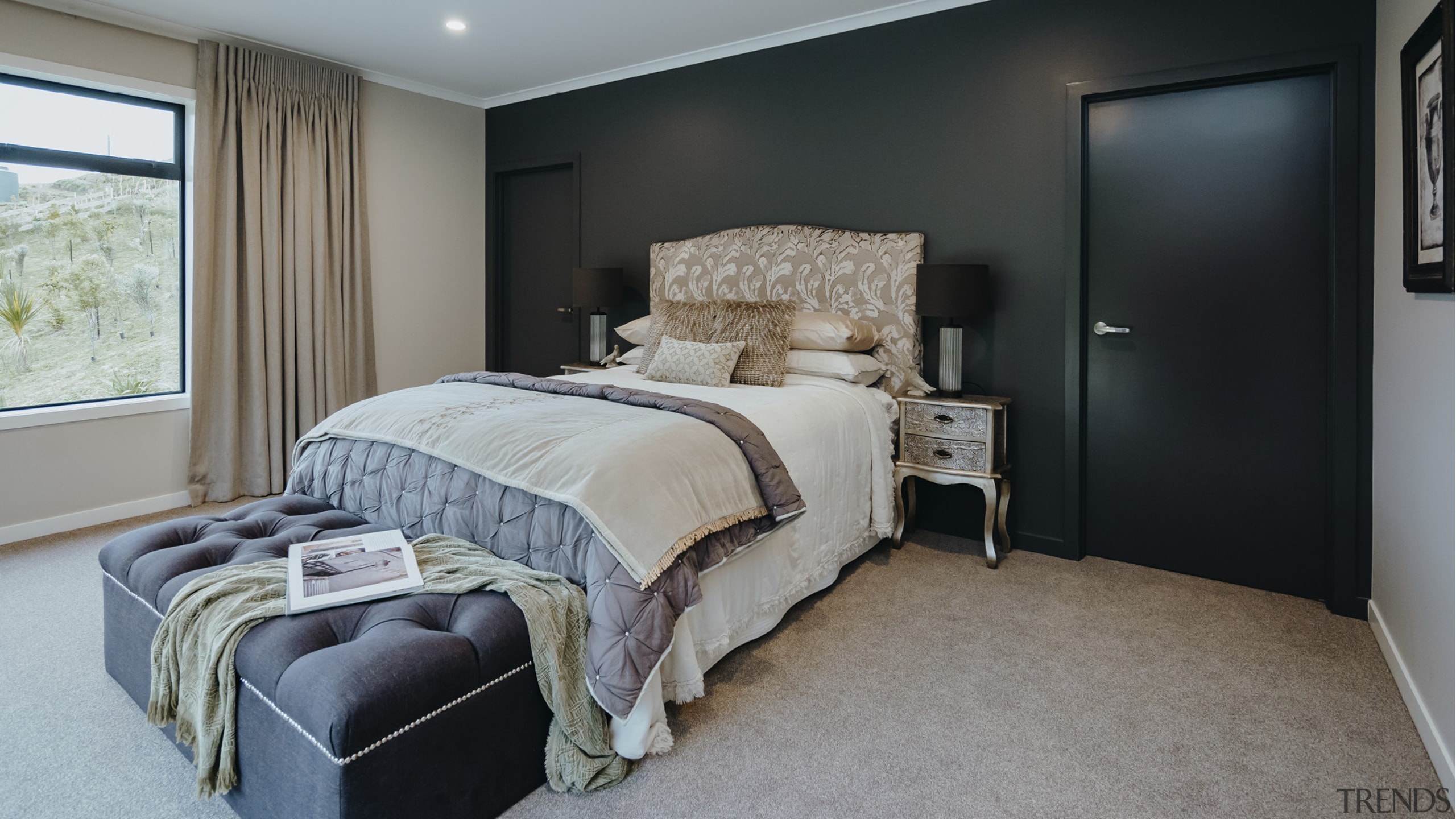 The master bedroom features a black accent wall 