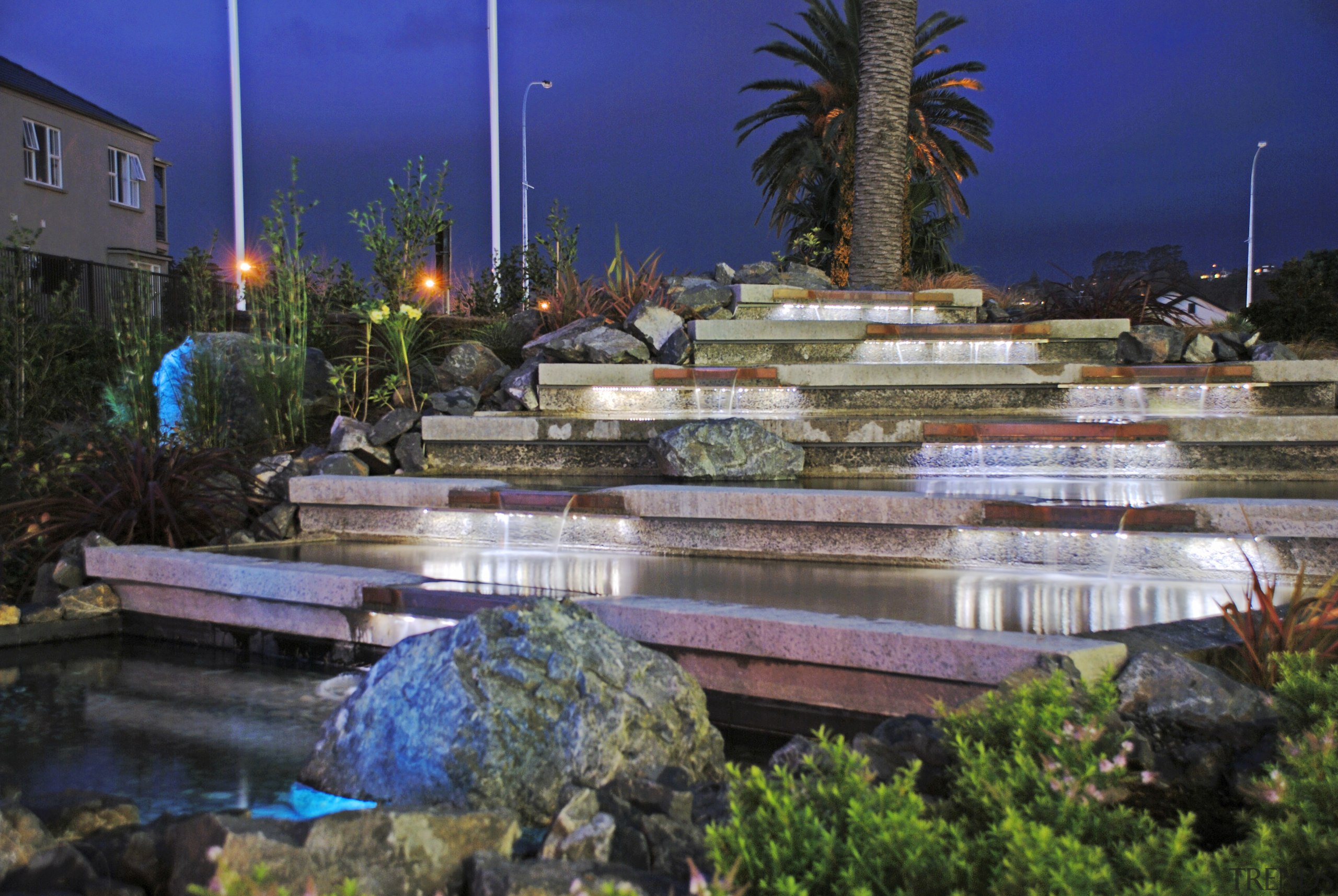 The entrance to this community garden was transformed arecales, fountain, landscape, landscape lighting, leisure, lighting, plant, reflecting pool, reflection, resort, resort town, swimming pool, tourist attraction, water, water feature, watercourse, black, blue