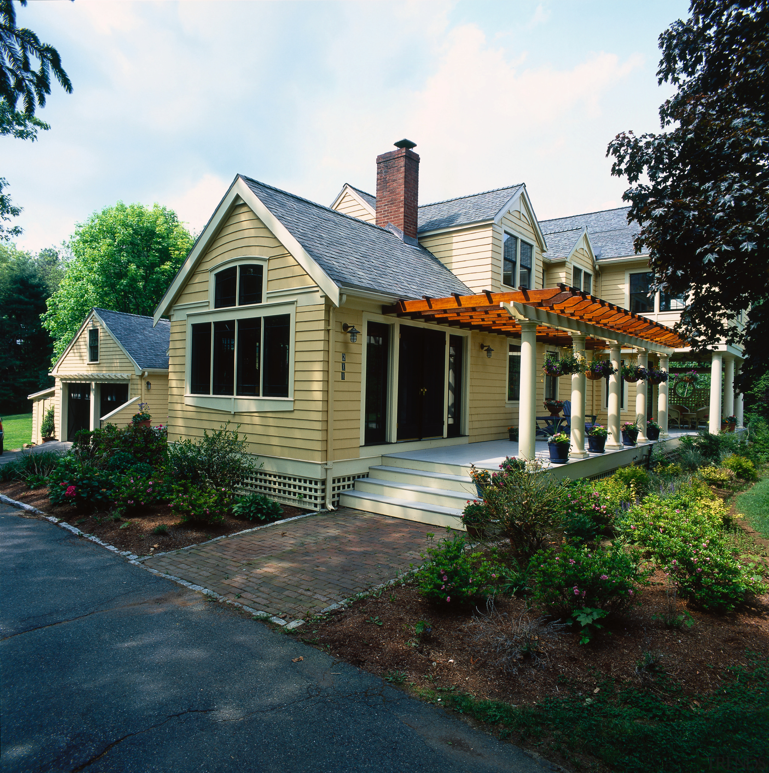 Exterior view of this home with large pergola cottage, estate, facade, farmhouse, historic house, home, house, landscaping, neighbourhood, property, real estate, residential area, roof, siding, suburb, window, yard, black, white