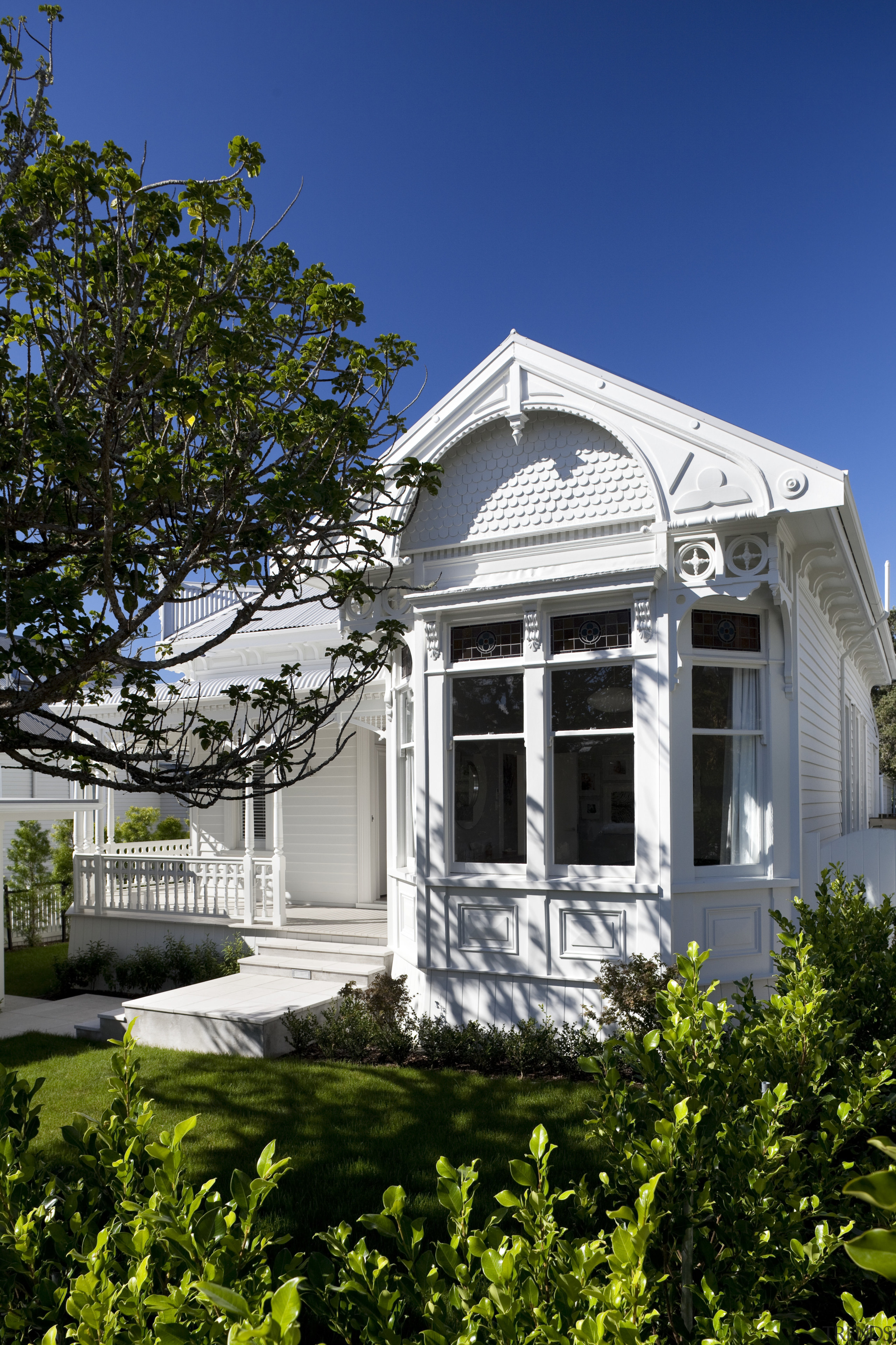 Exterior of house with lawn and plants in architecture, building, cottage, daytime, estate, facade, historic house, home, house, landmark, mansion, neighbourhood, plant, property, real estate, residential area, sky, tree, villa, window, blue