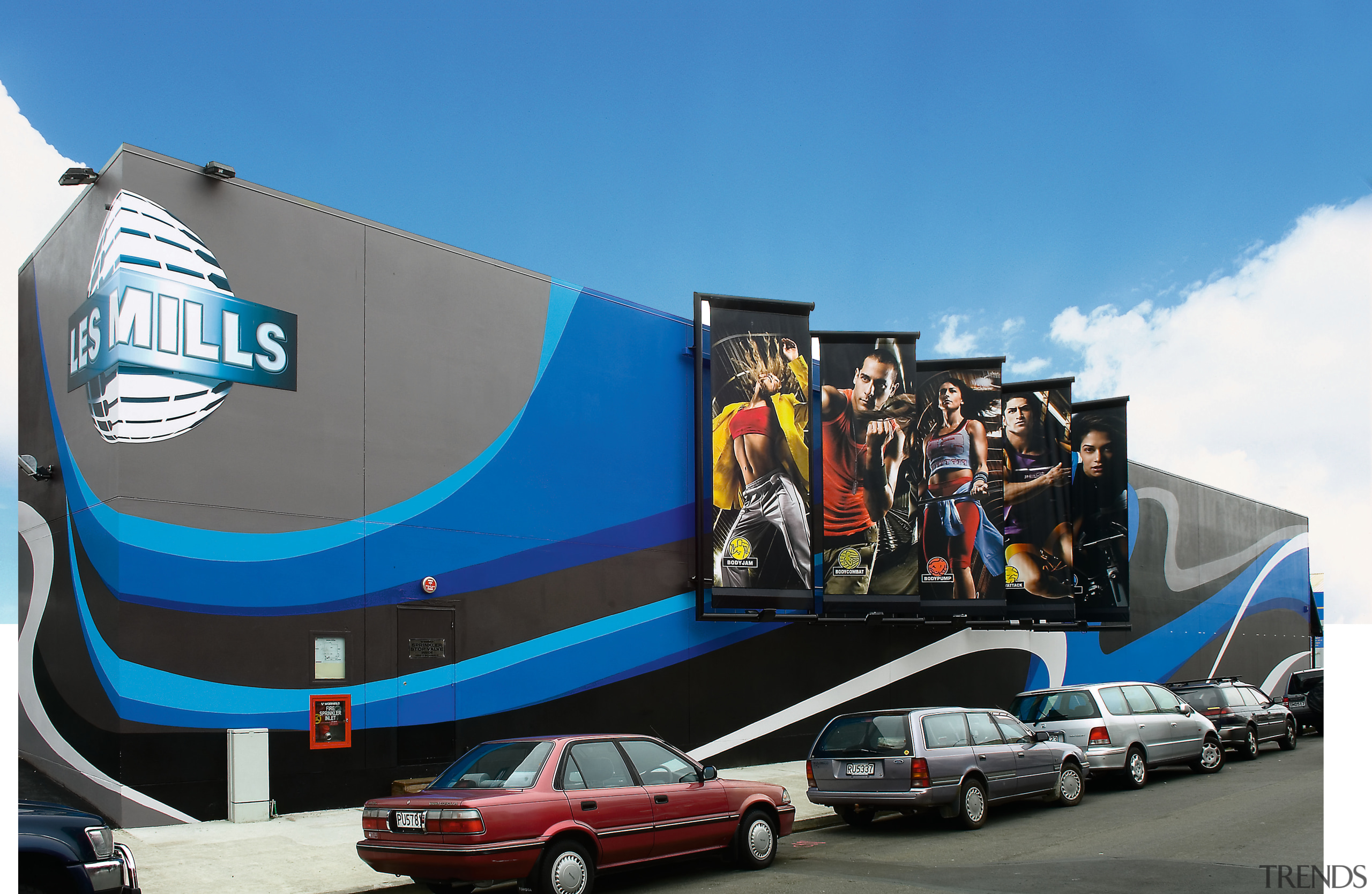 view of the less mills building constructed by advertising, blue, car, mural, sky, transport, vehicle, teal