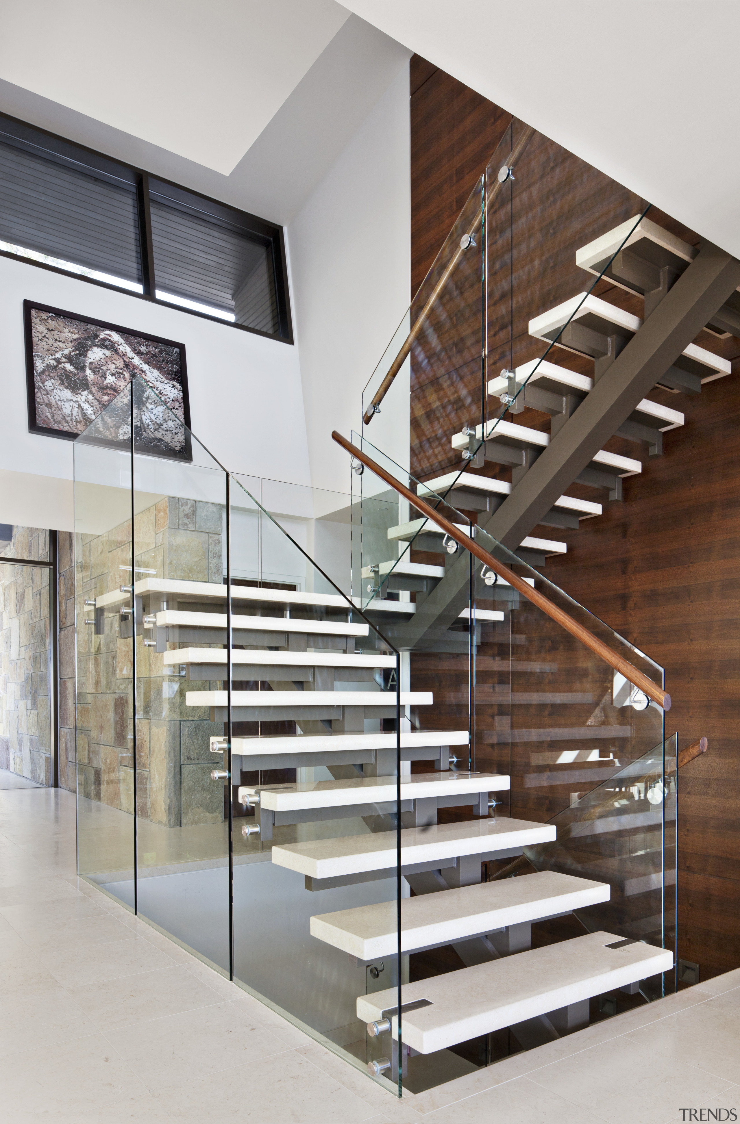 This is a home that was designed by baluster, glass, handrail, interior design, product design, stairs, gray