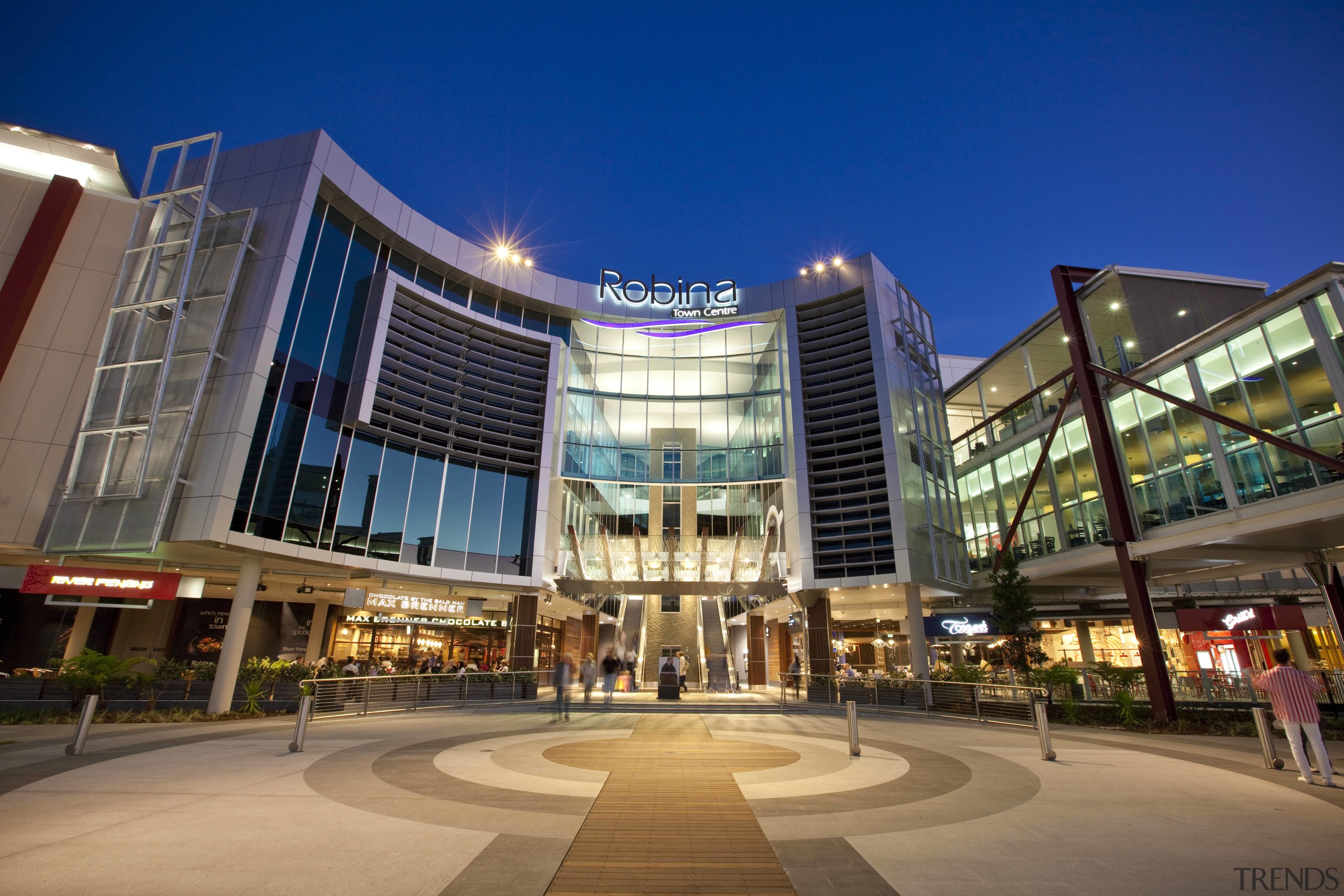 Exterior view of the Robina Town Centre where architecture, building, city, commercial building, condominium, convention center, corporate headquarters, downtown, headquarters, hotel, metropolis, metropolitan area, mixed use, night, plaza, real estate, residential area, shopping mall, sky, blue