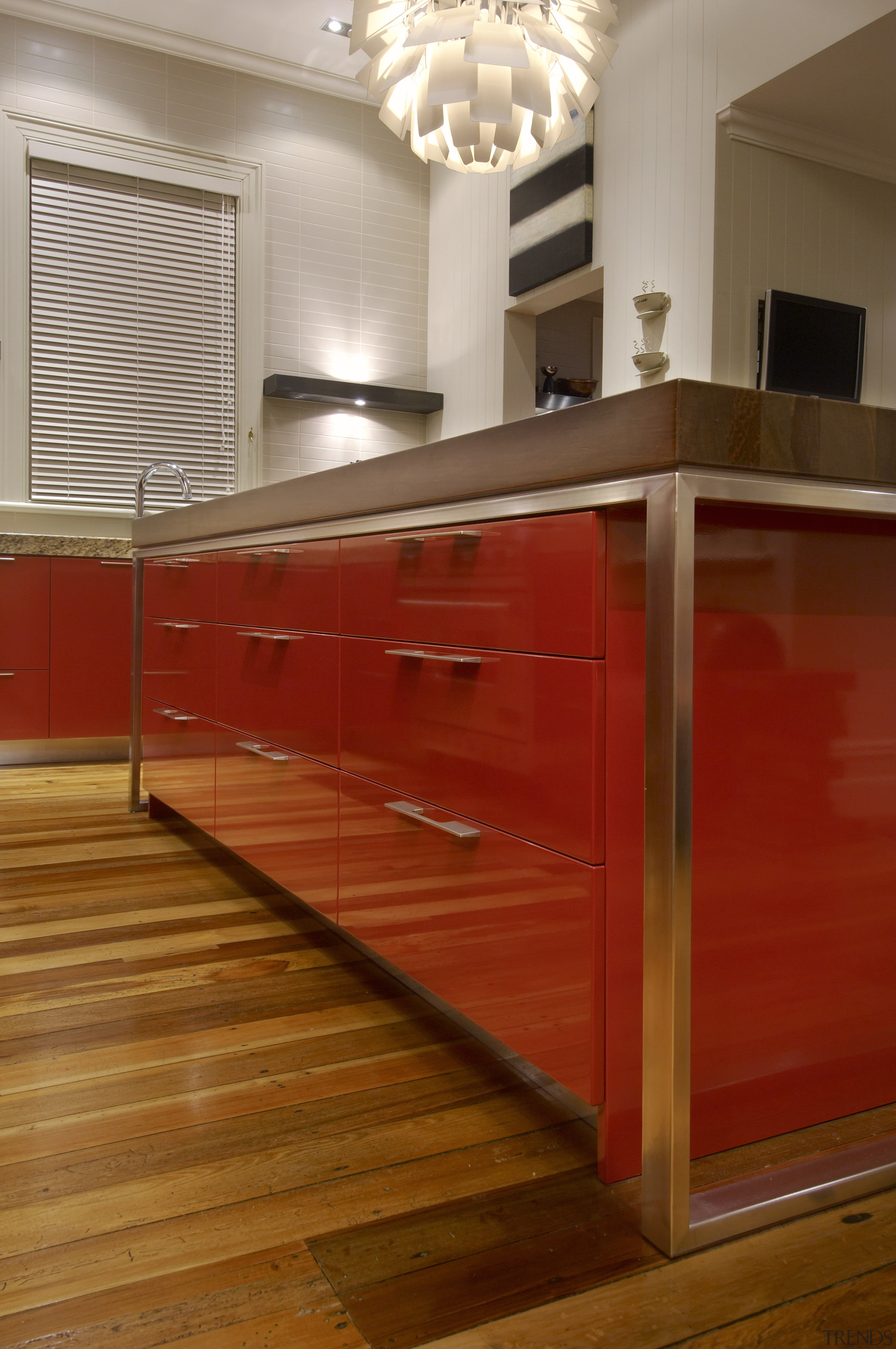 View of a modern kitchen which features a cabinetry, chest of drawers, countertop, drawer, floor, flooring, furniture, hardwood, interior design, kitchen, laminate flooring, room, table, wall, wood, wood flooring, wood stain, brown