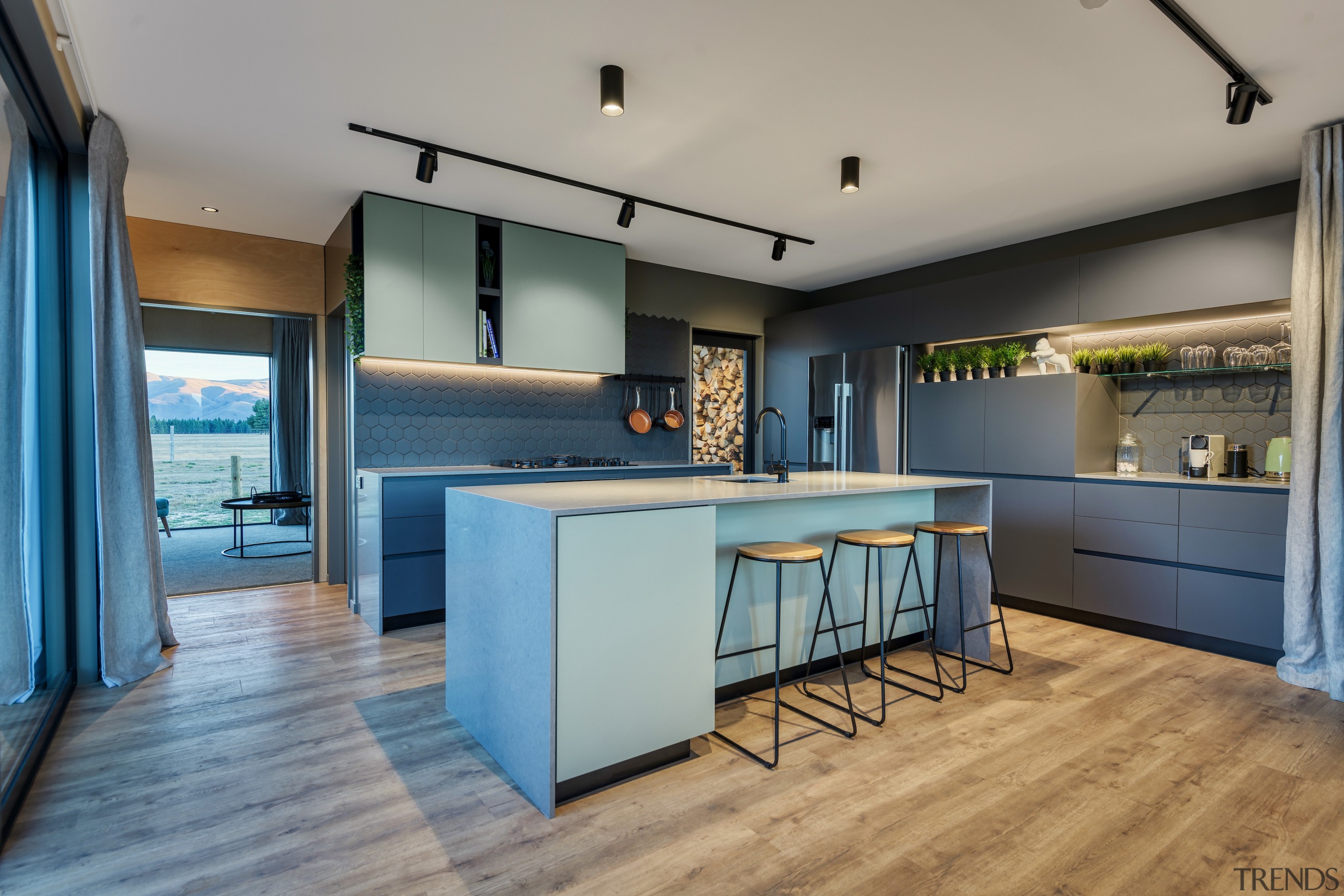 The splash of Melteca Bayleaf green cabinetry not 