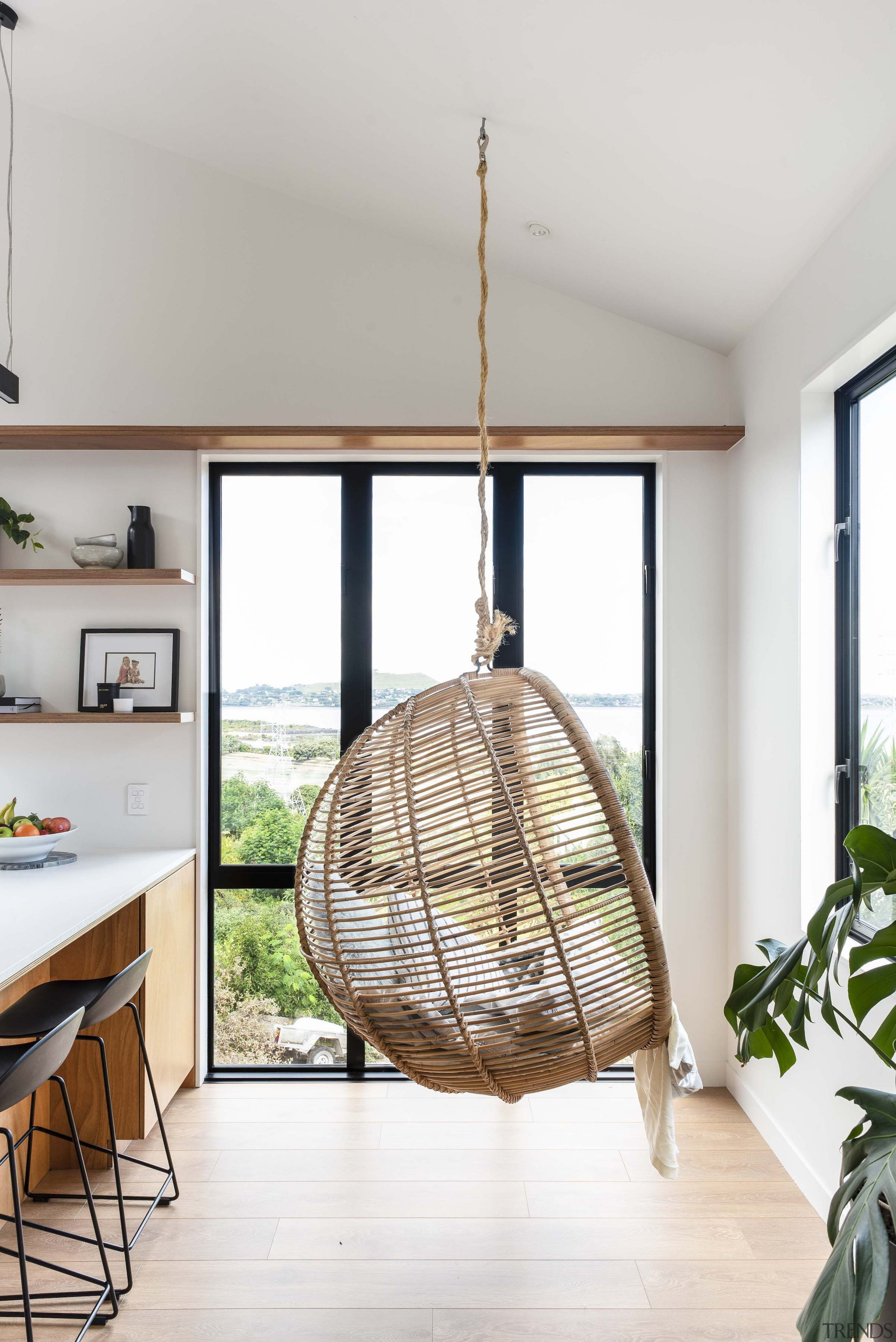 The feature hanging chair in the kitchen-dining area 