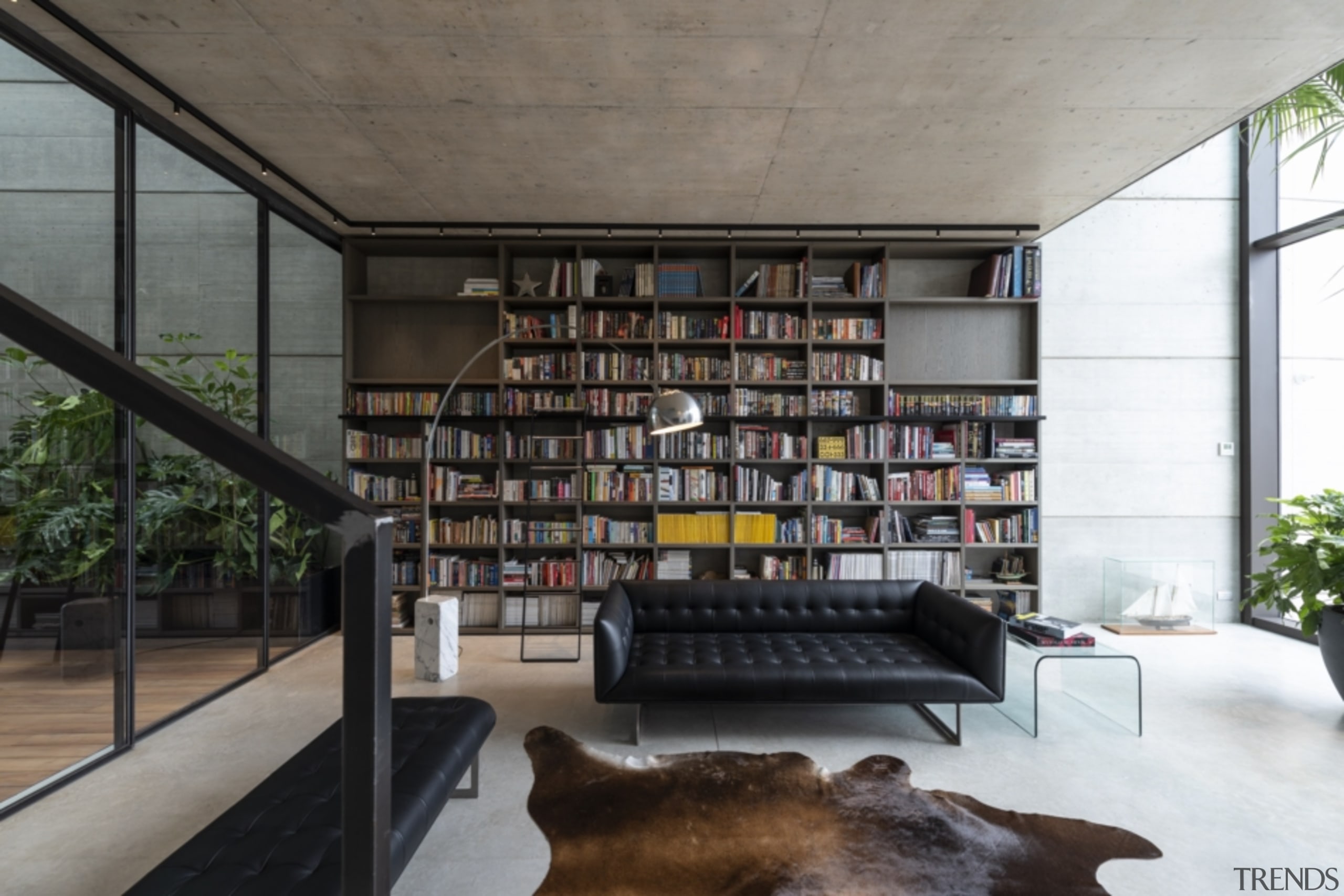 Floor-to-ceiling glazing ensures the home is light-filled and architecture, bookcase, building, ceiling, furniture, home, house, interior design, library, living room, loft, room, shelf, shelving, gray, black