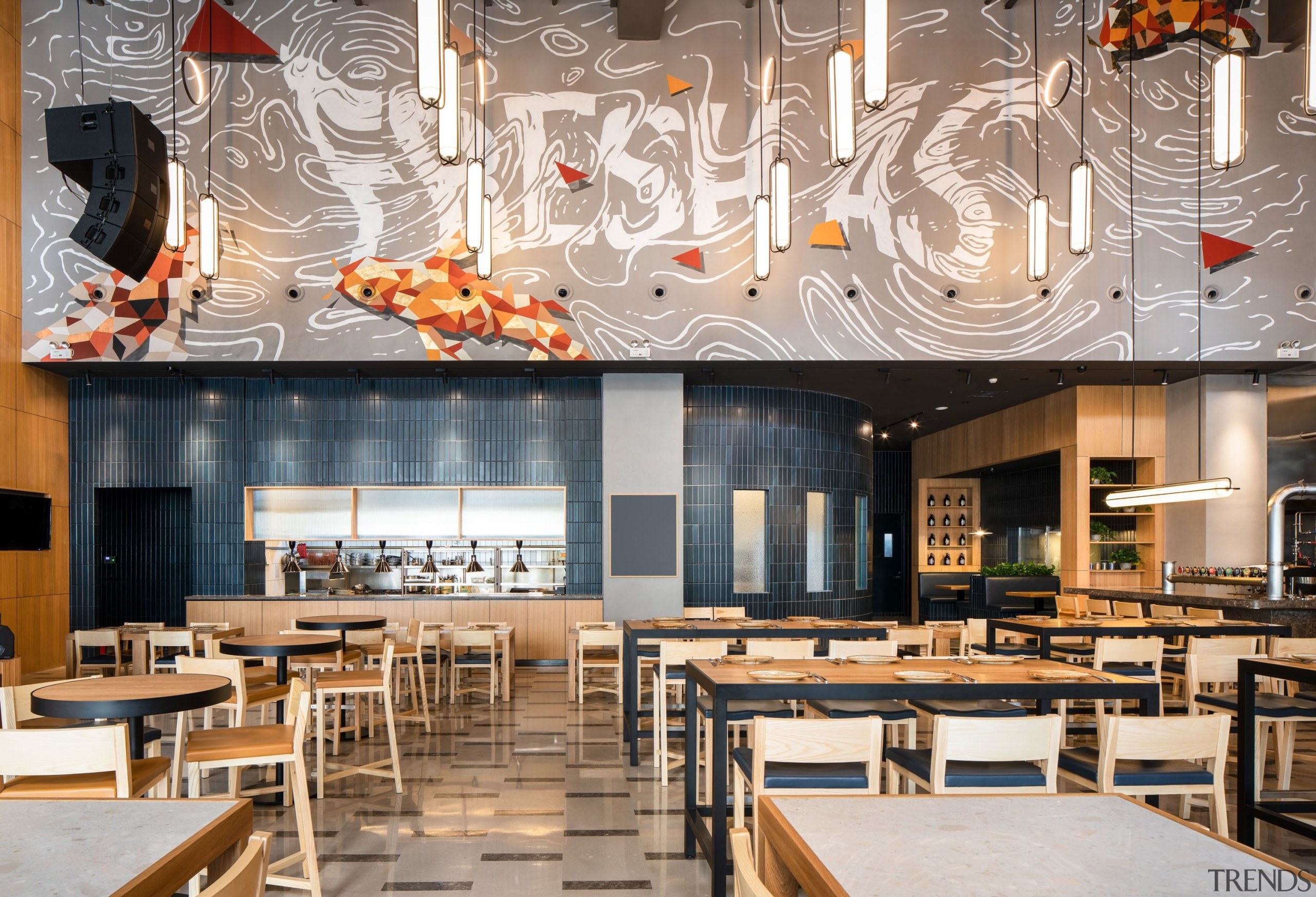 Above the open kitchen, a mural of stylised architecture, brunch, building, café, cafeteria, ceiling, coffeehouse, design, dining room, fast food restaurant, food court, furniture, interior design, lighting, restaurant, room, table, gray