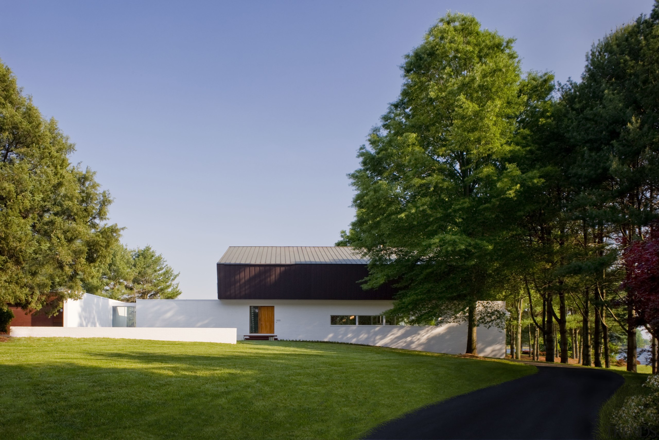 View of contemporary home. - View of contemporary architecture, cottage, estate, facade, farmhouse, grass, home, house, landscape, lawn, plant, property, real estate, residential area, sky, tree, brown