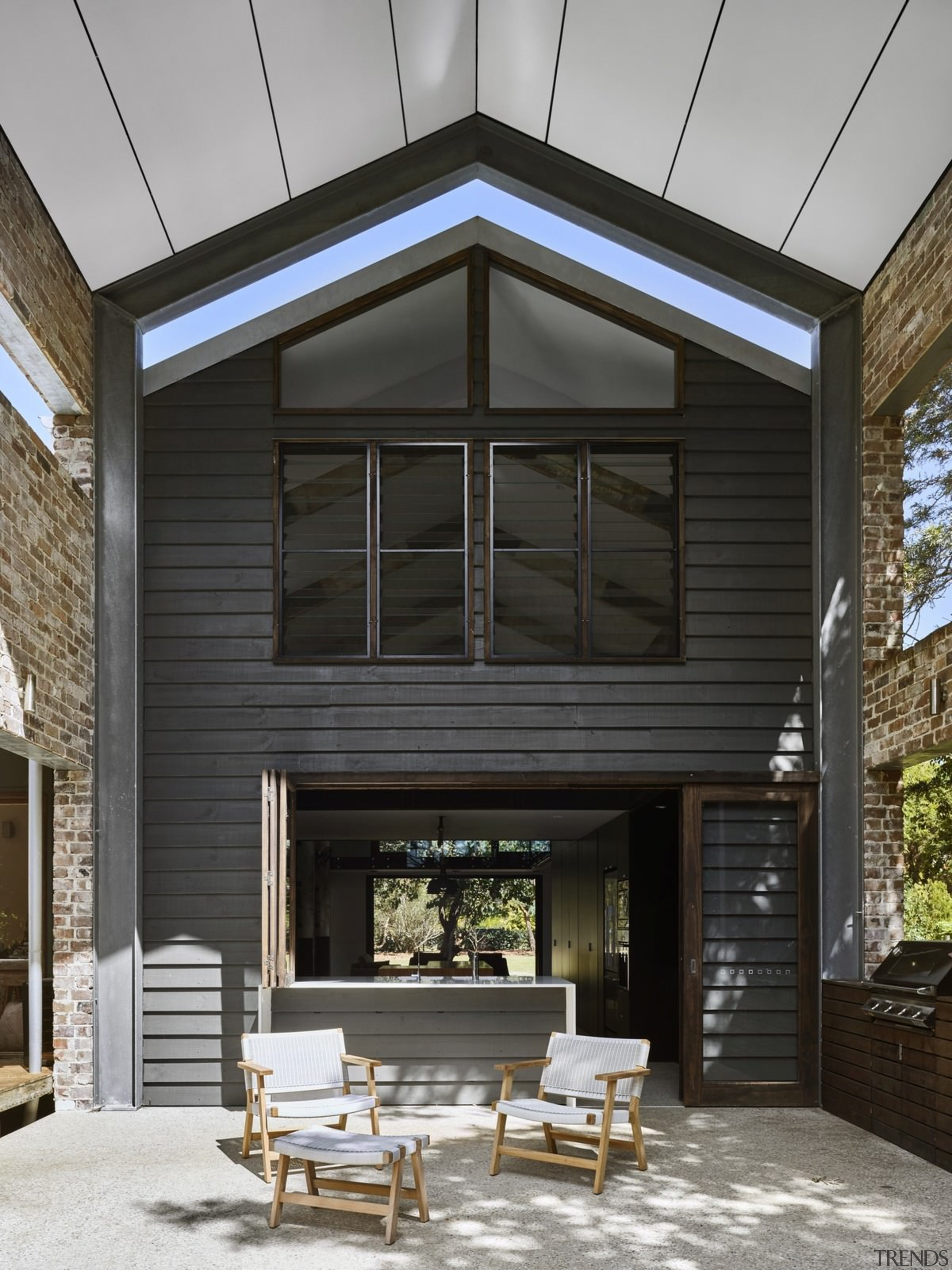 A view of the outdoor room - A facade, home, house, interior design, residential area, siding, window, black, gray