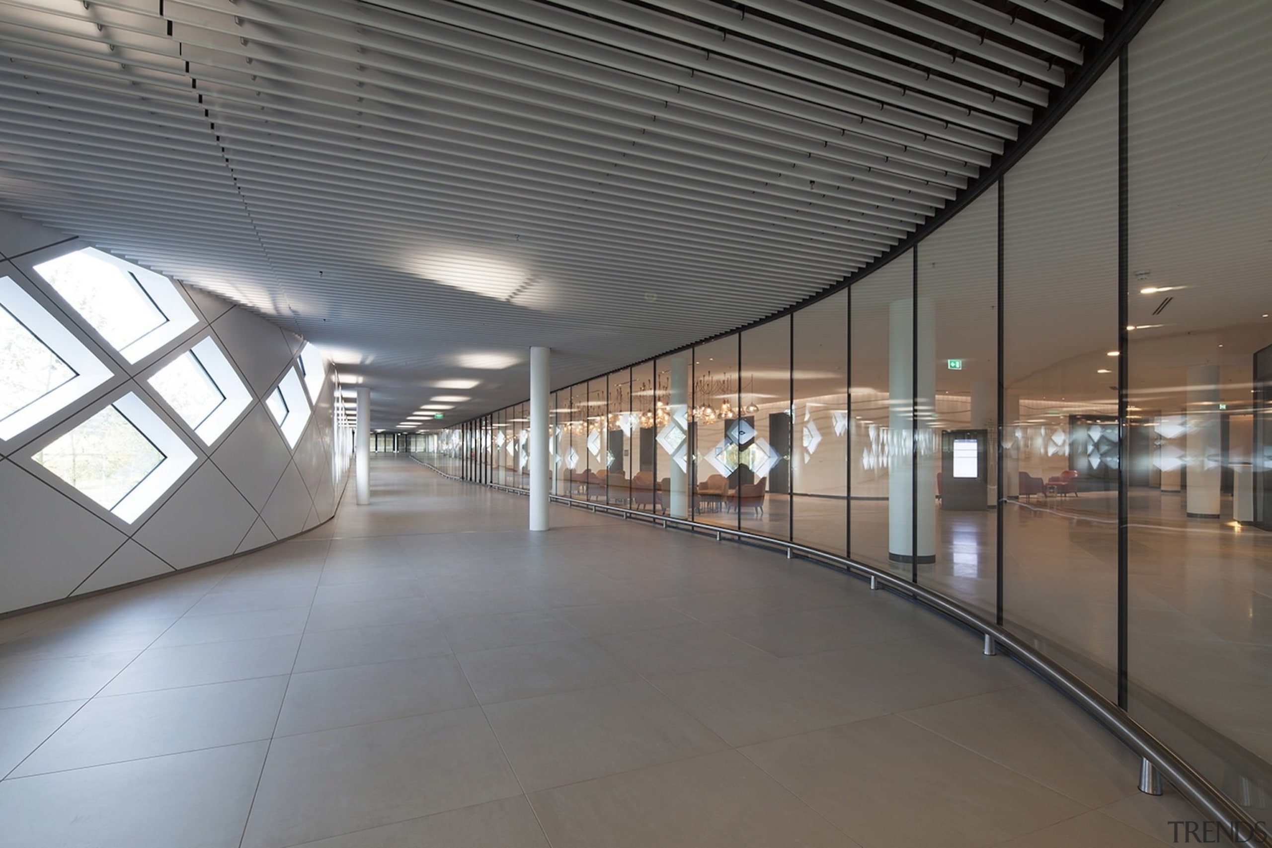 This hallway runs between the exterior wall and airport terminal, architecture, ceiling, daylighting, floor, leisure centre, lobby, metropolitan area, structure, gray