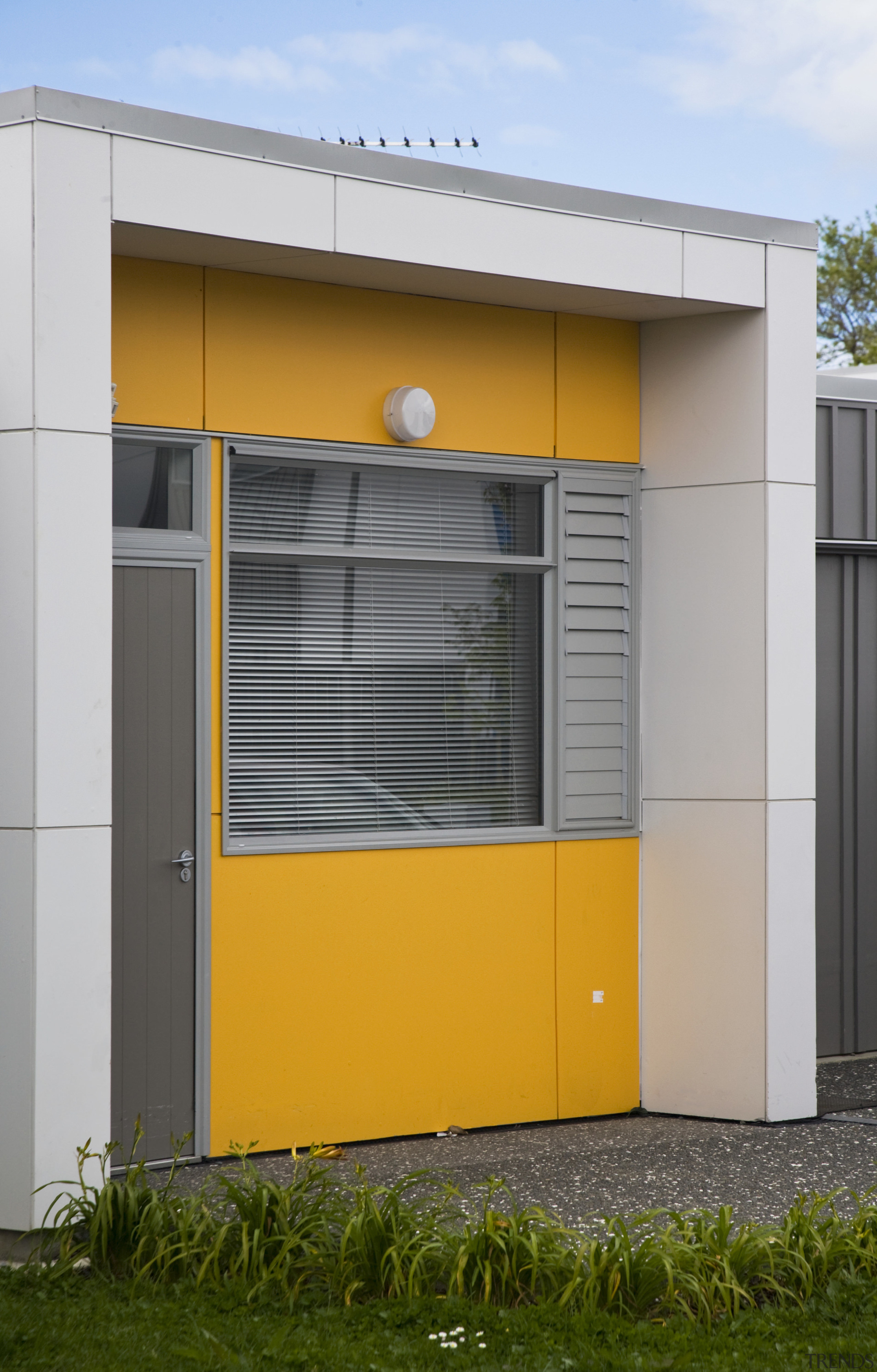 This Housing New Zealand Devlopment features modular homes, architecture, door, facade, house, yellow, gray