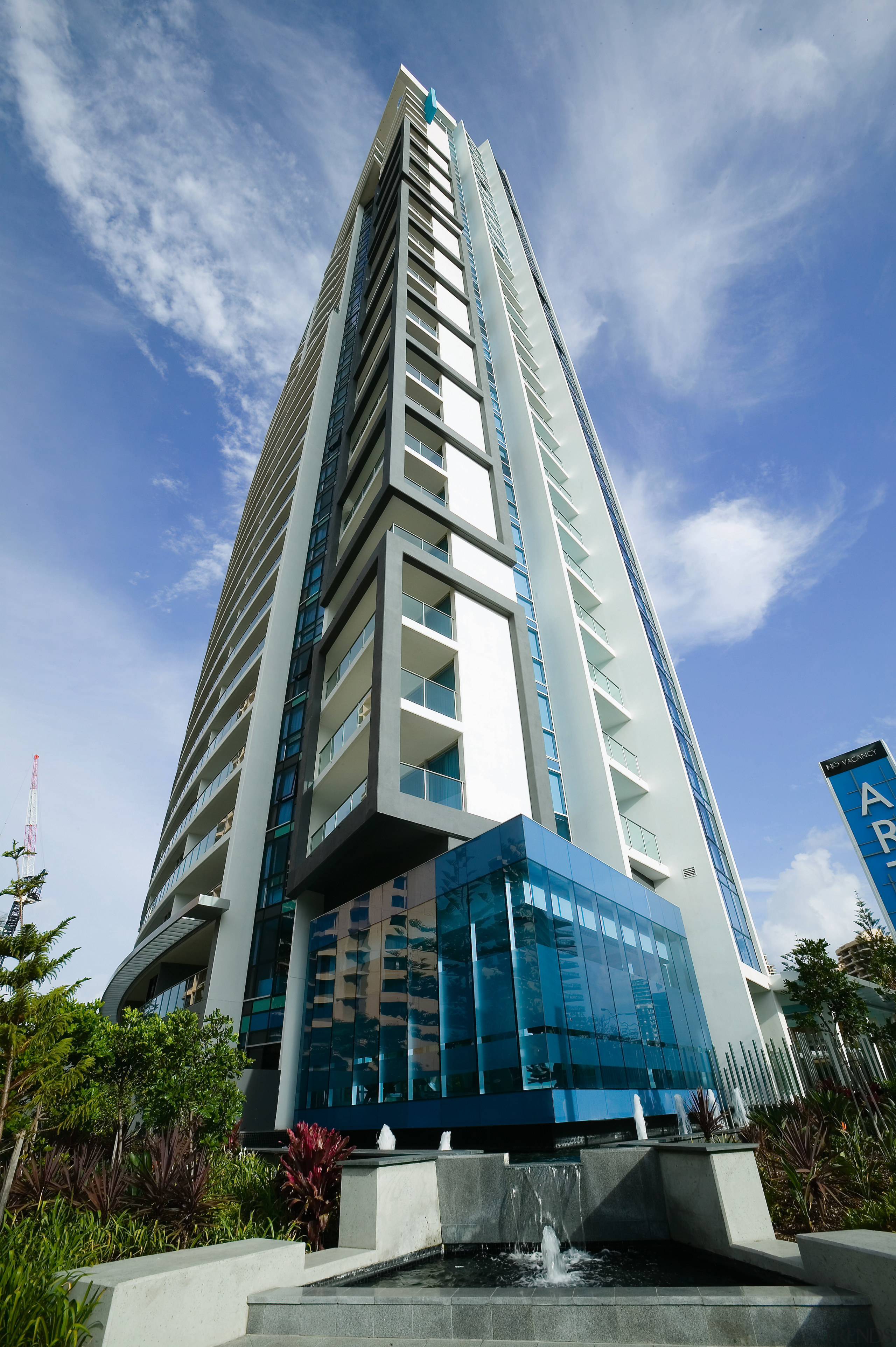 An exterior view of the Artique apartment complex architecture, building, commercial building, condominium, corporate headquarters, daytime, headquarters, metropolis, metropolitan area, mixed use, sky, skyscraper, tower, tower block, teal