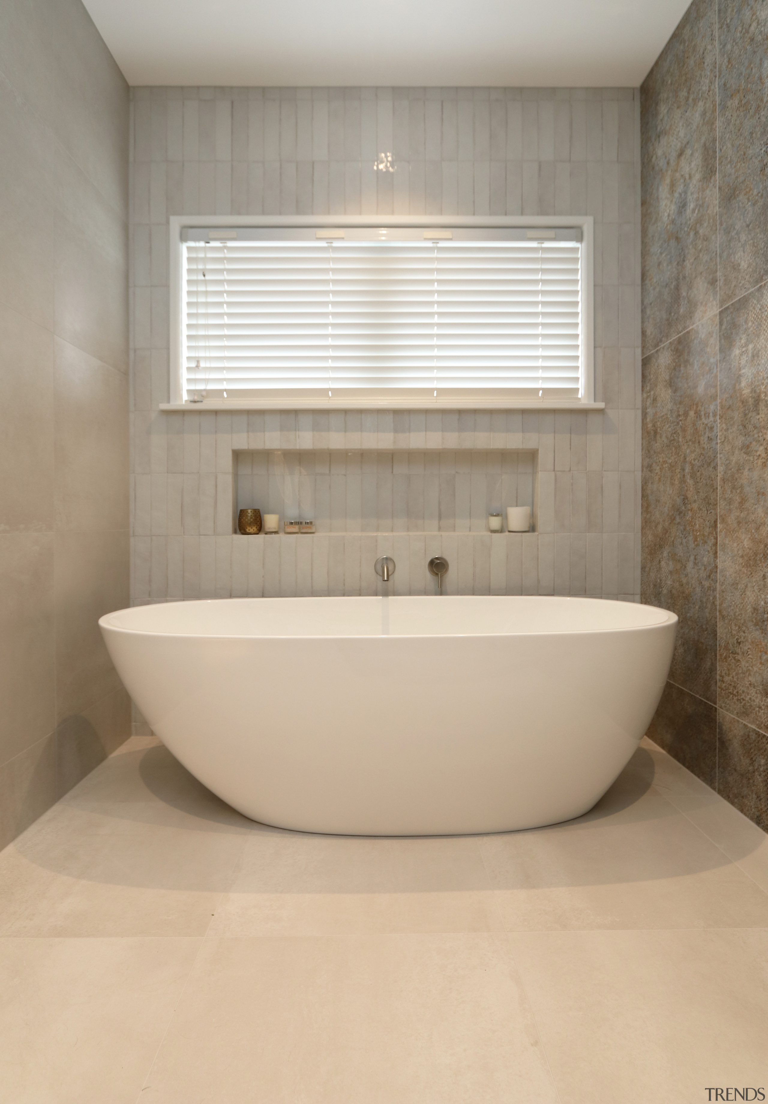 A shapely freestanding bath and sophisticated tile choices 