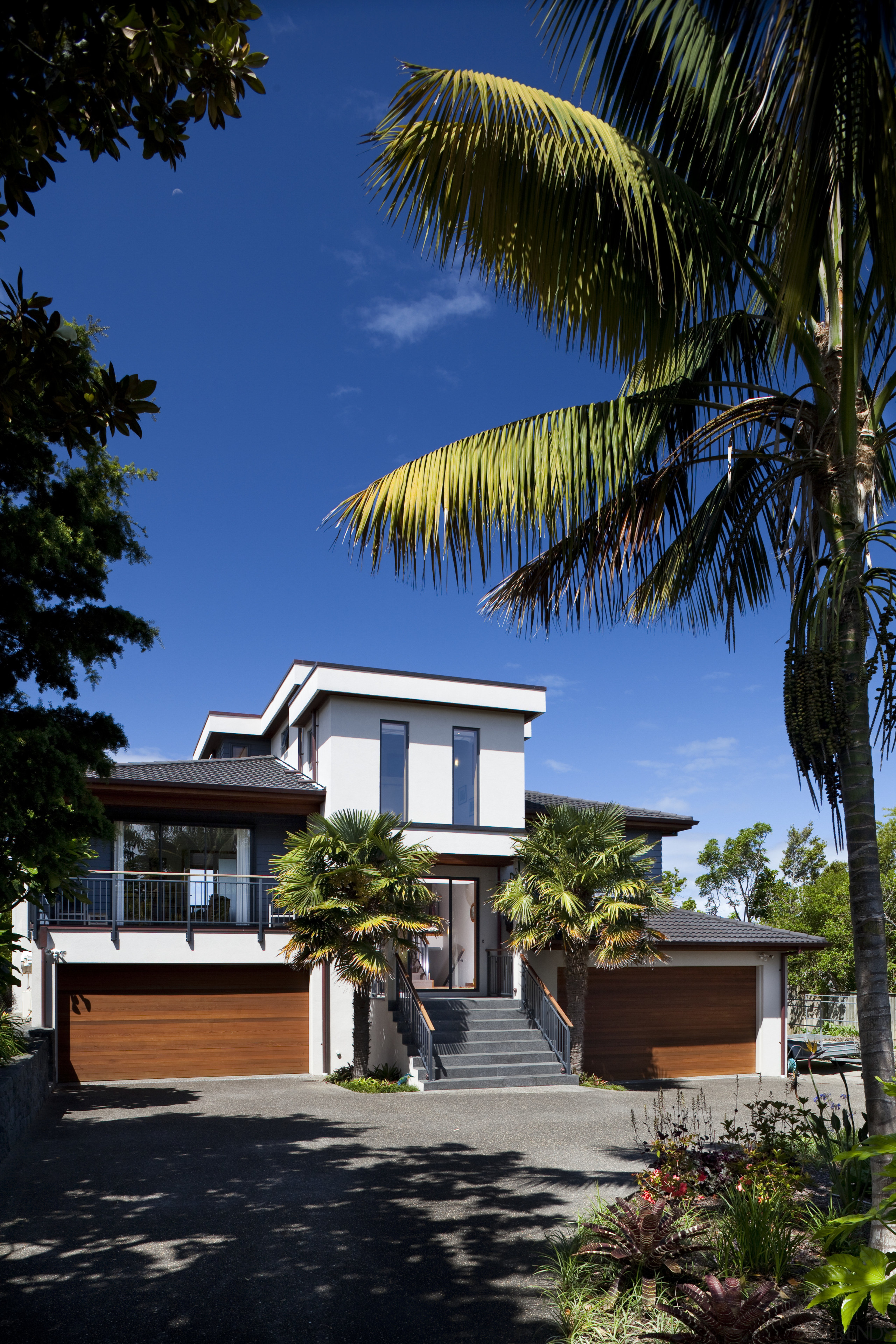 This home was designed and built by Signature architecture, arecales, building, condominium, cottage, daytime, estate, facade, home, house, palm tree, plant, property, real estate, residential area, resort, sky, tree, tropics, villa, black