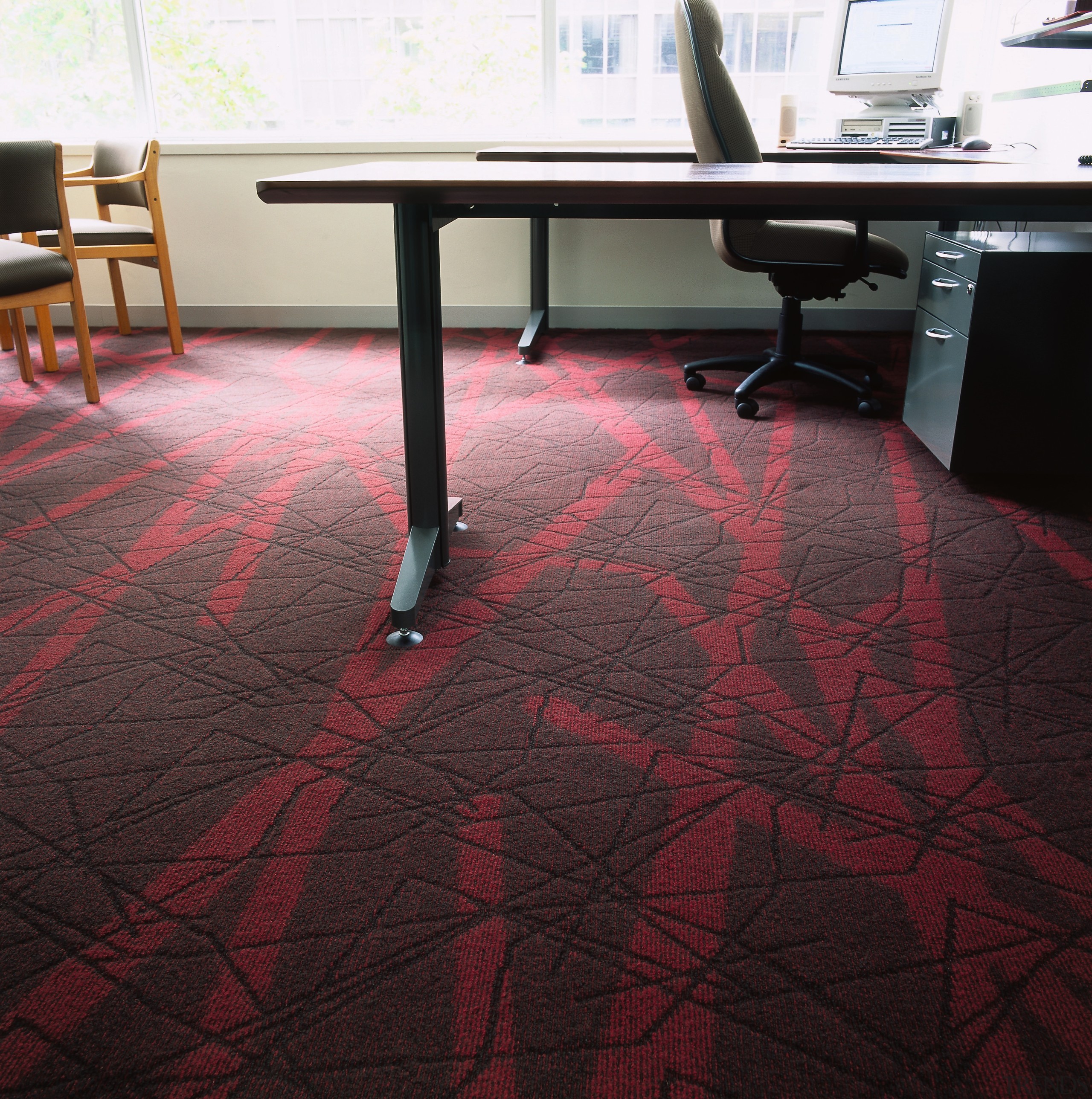 Textured carpet with red pattern in office with carpet, chair, floor, flooring, furniture, hardwood, laminate flooring, table, tile, wood, wood flooring, wood stain, black