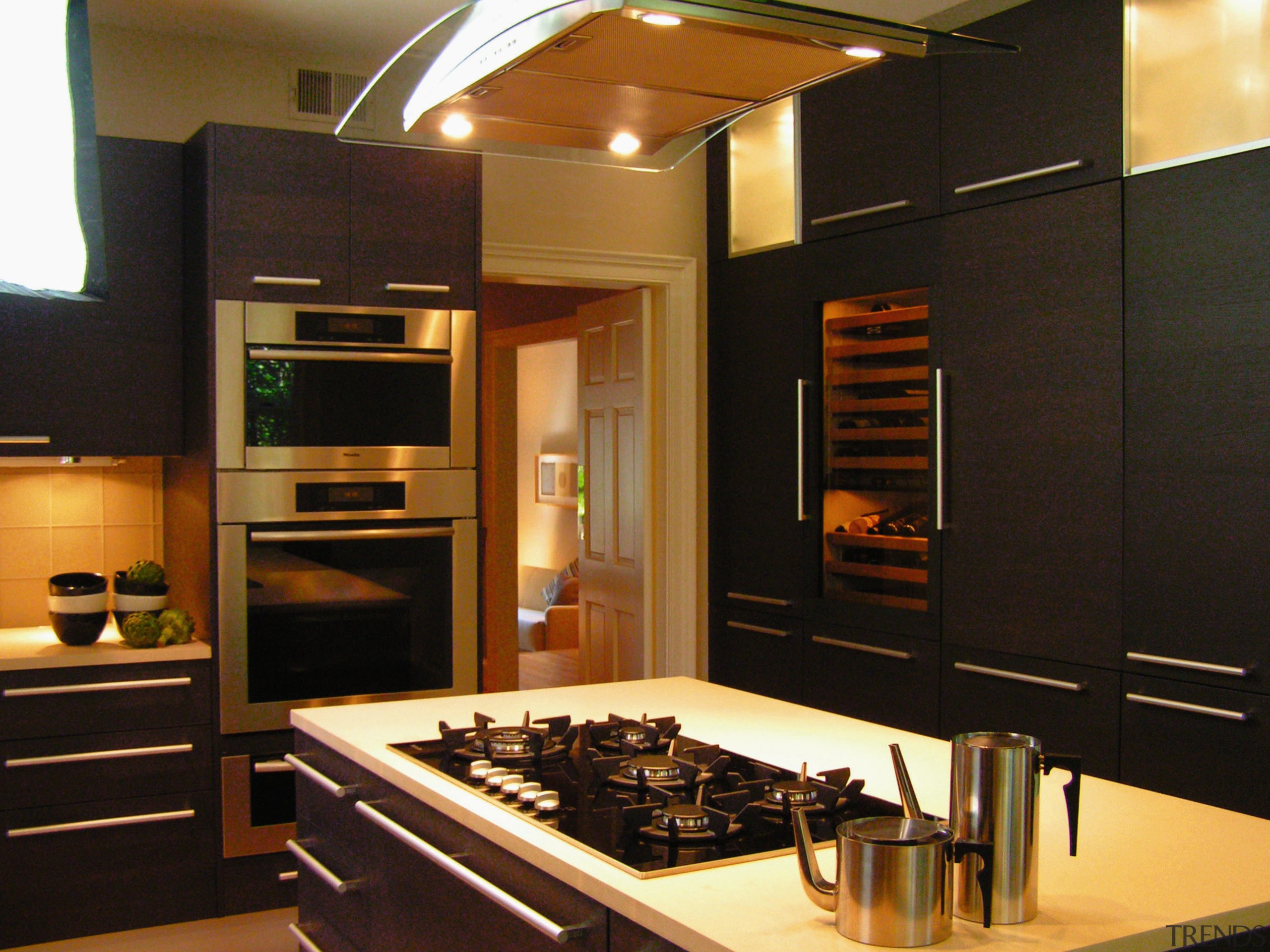 A view of this kitchen features cabinets by cabinetry, countertop, interior design, kitchen, room, black, brown