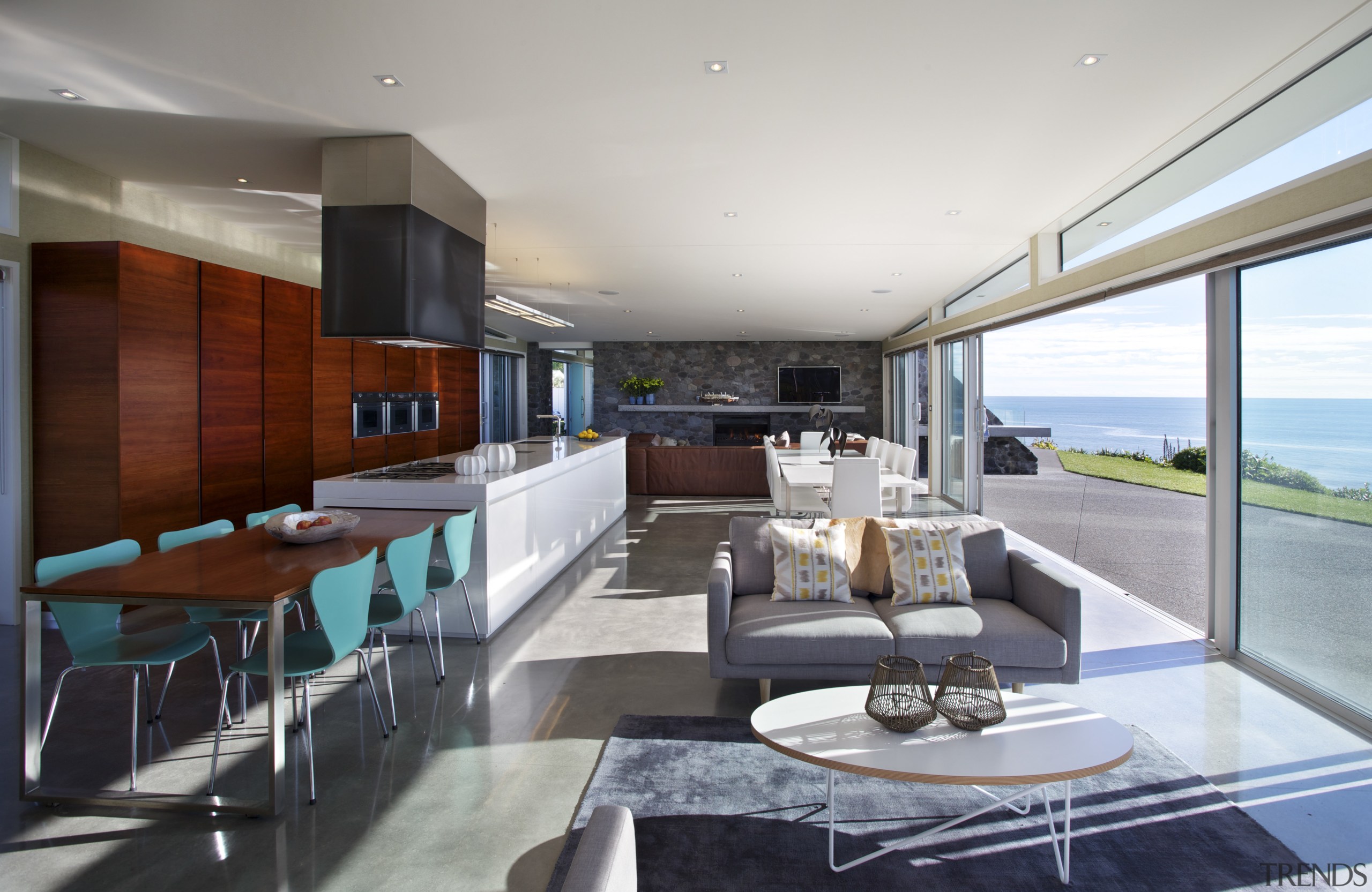 A very long open-plan living space is a apartment, architecture, ceiling, house, interior design, living room, penthouse apartment, property, real estate, gray