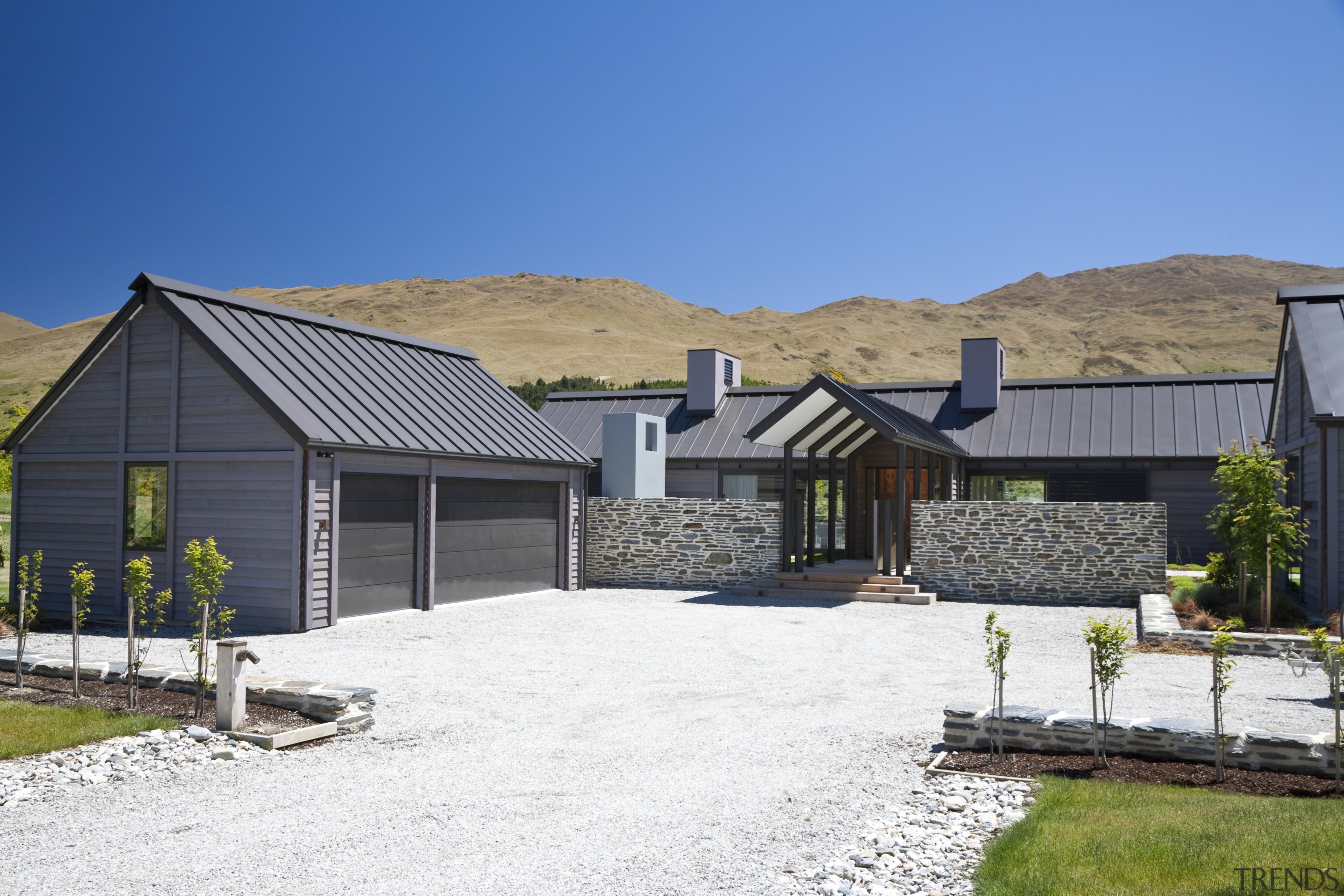 Exterior view of a country home which features barn, cottage, elevation, estate, facade, farmhouse, home, house, landscape, mountain, property, real estate, residential area, roof, shed, siding, sky, white