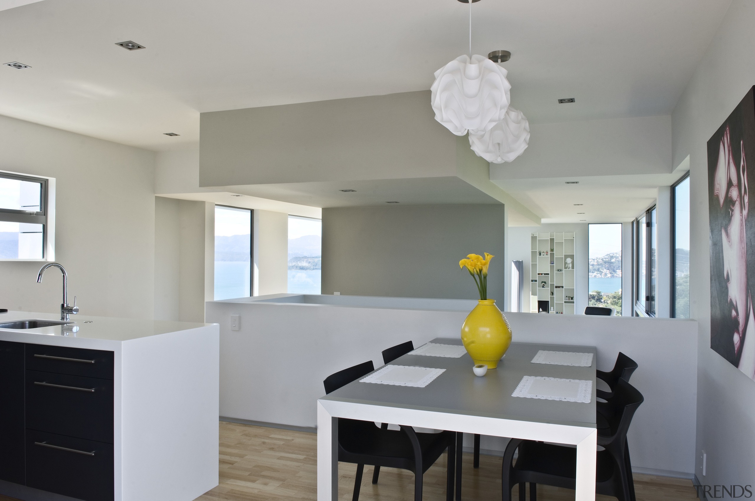 Kitchen and dining area inside contemporary home featuring apartment, architecture, ceiling, dining room, home, house, interior design, kitchen, property, real estate, room, gray