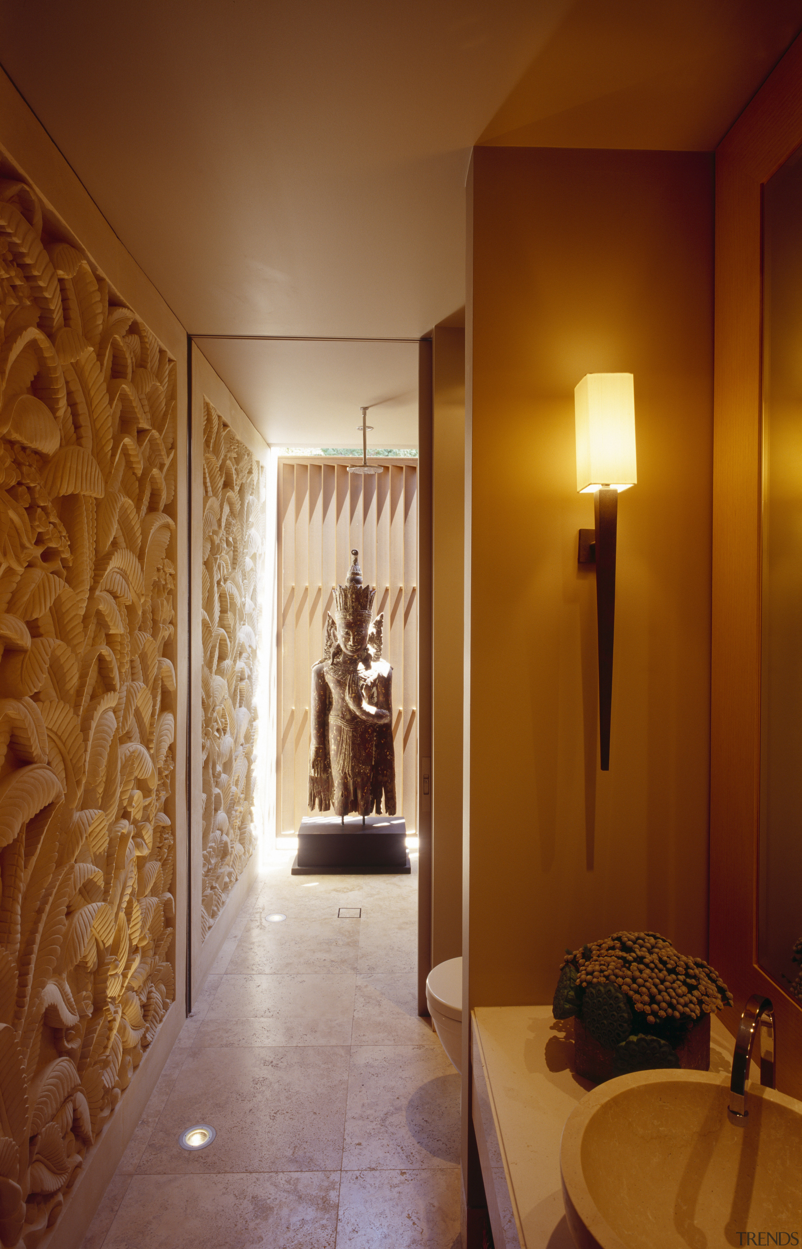 view of powder room featuring carved limestone wall, ceiling, floor, flooring, home, interior design, light fixture, lighting, lobby, room, wall, wood, brown