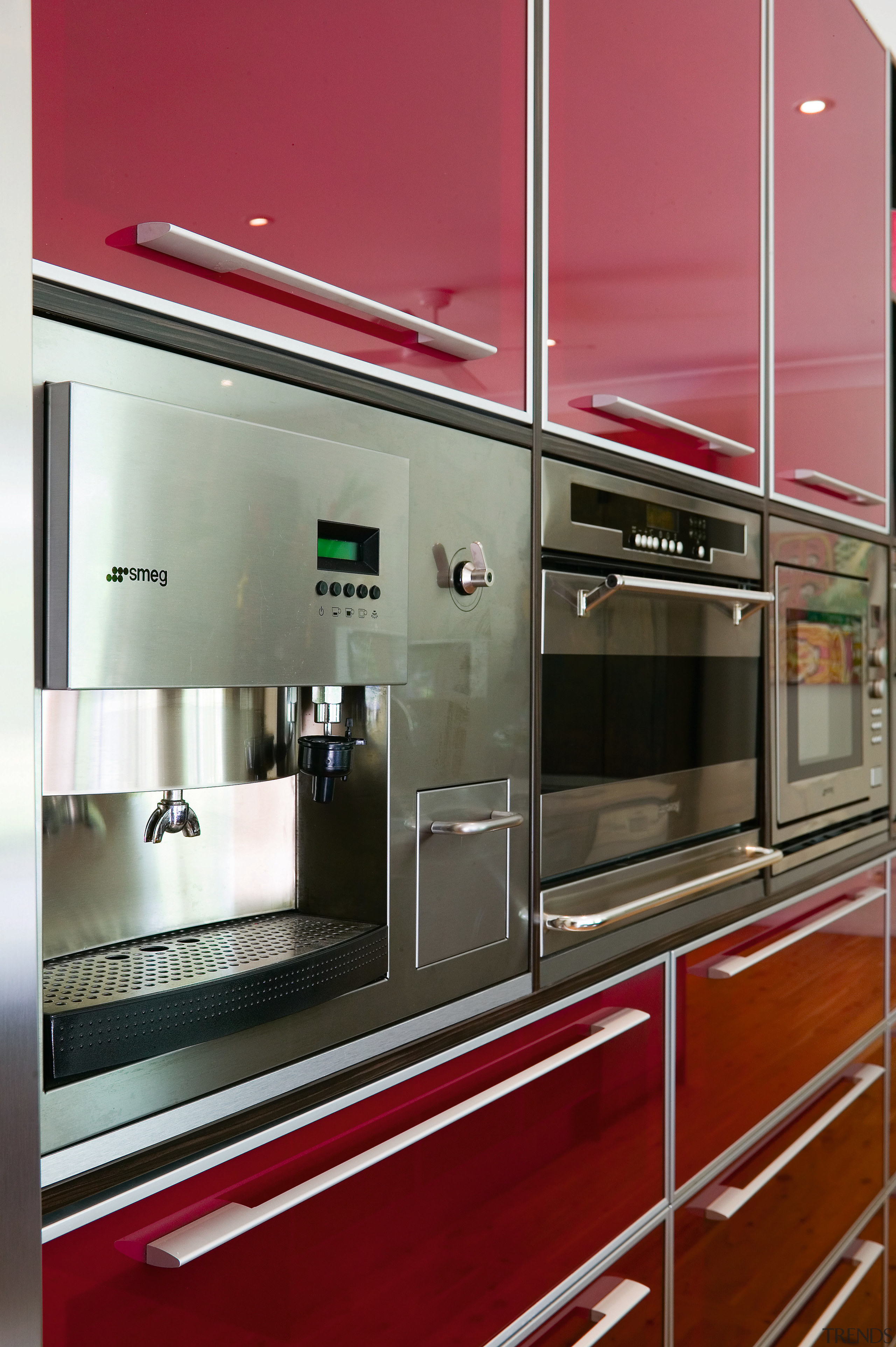 A close up view of an Omega Smeg cabinetry, countertop, glass, home appliance, interior design, kitchen, red