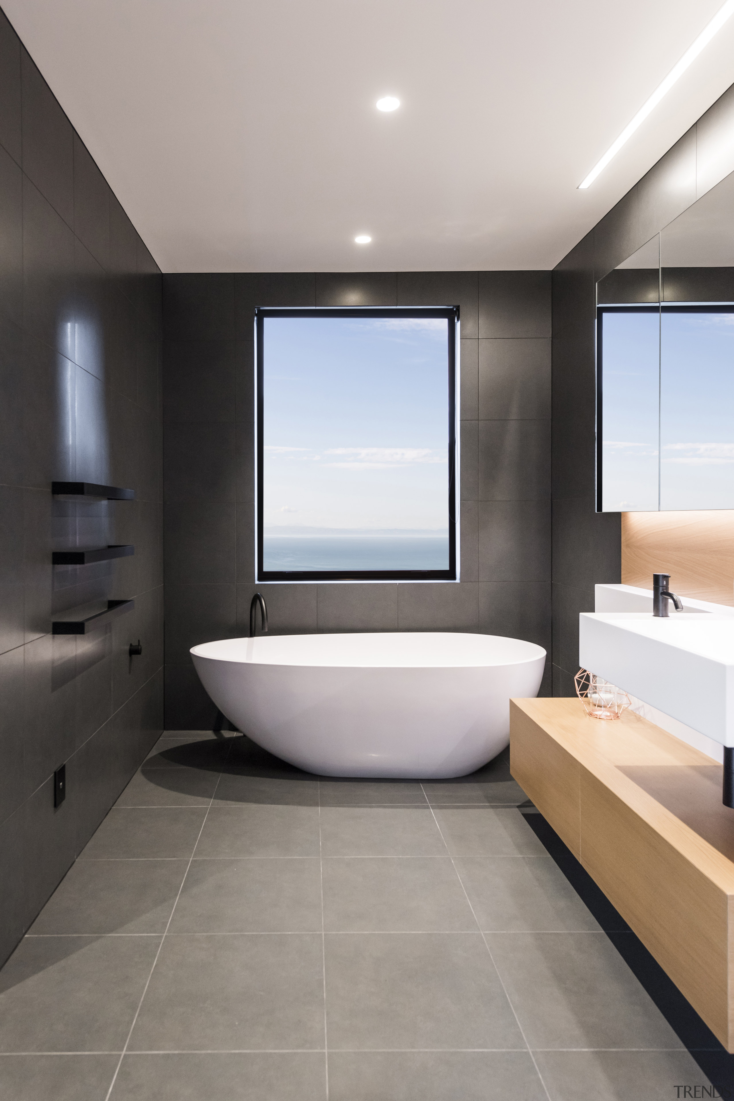 ​​​​​​​For this bathroom by designer Davinia Sutton, shapes architecture, bathroom, floor, flooring, interior design, tile, gray, black, Freestanding bath, Davinia Sutton