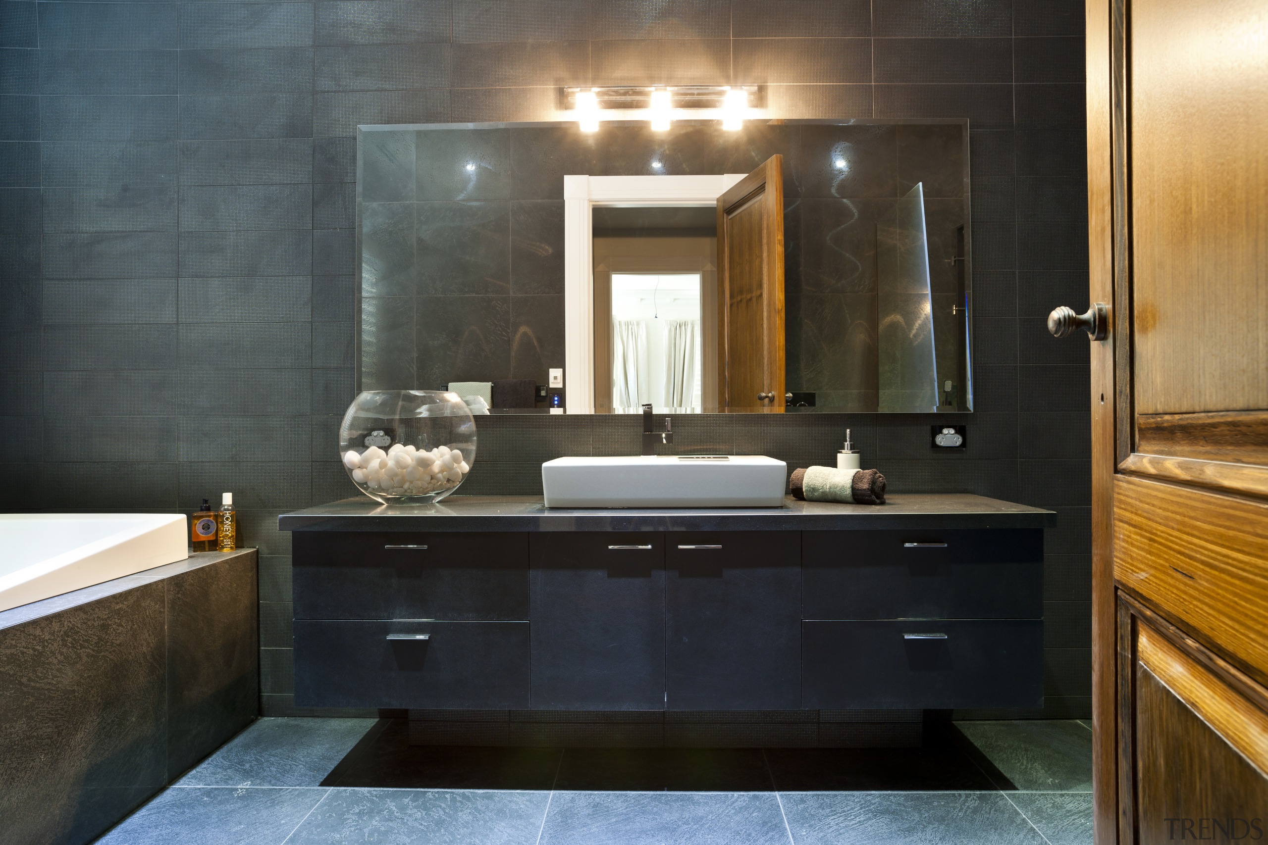 Bathroom with dark grey walls, dark... Gallery 1 Trends
