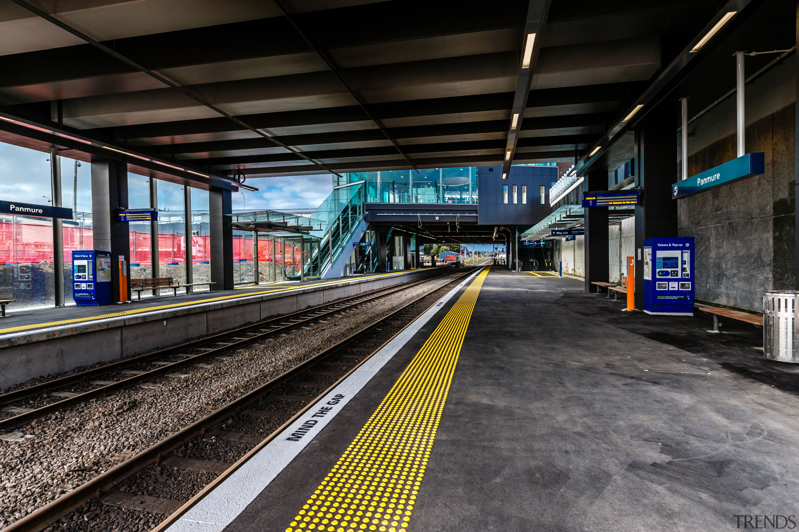 A substantial, timber-clad gullwing roof appears to float metro station, metropolitan area, public transport, rail transport, rapid transit, rolling stock, track, train, train station, transport, black