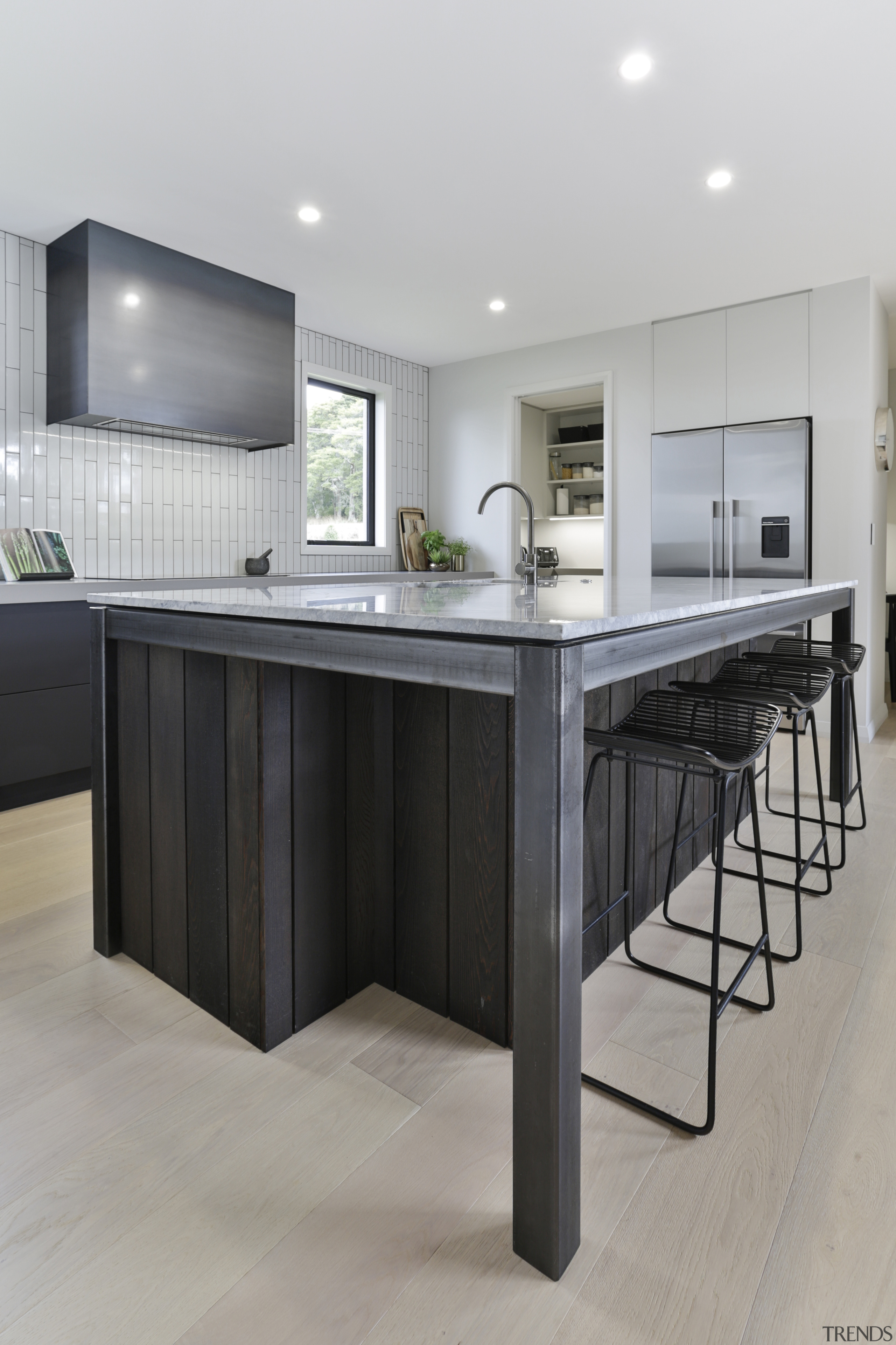 ​​​​​​​The steel frame on this island responds to architecture, Kitchen, cabinetry, countertop, island, industrial, rangehood, Kyla Potter, Carliele Kitchens