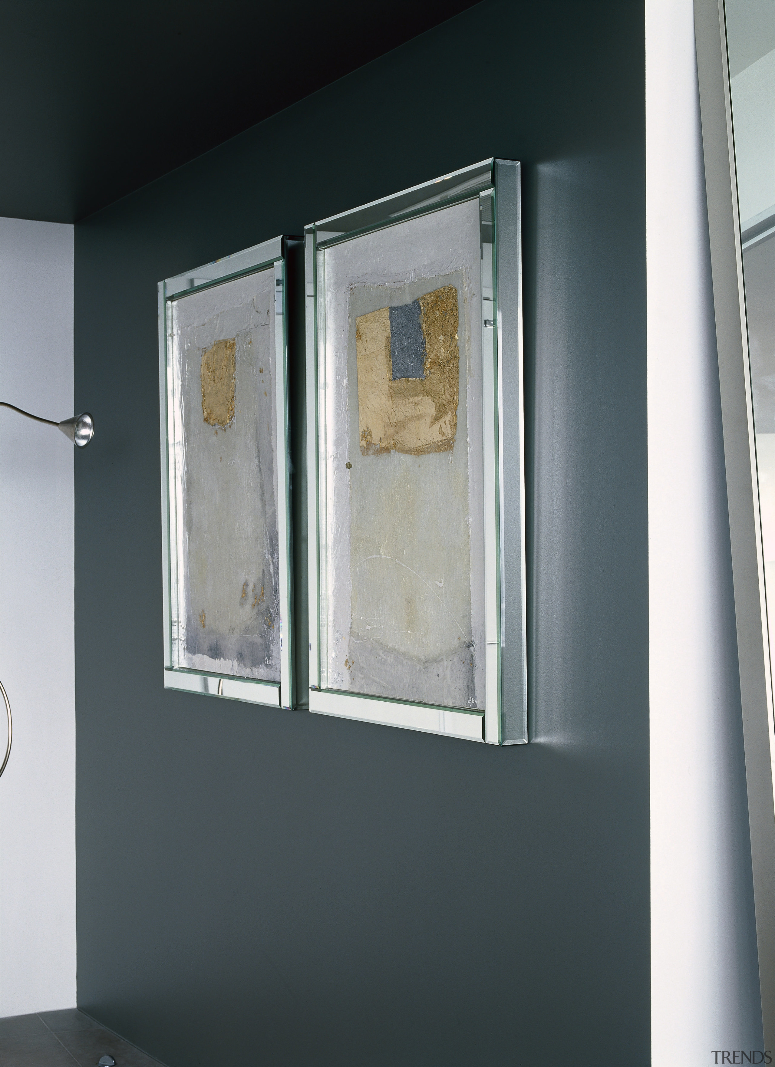 View of two side by side paintings against door, glass, window, gray, black