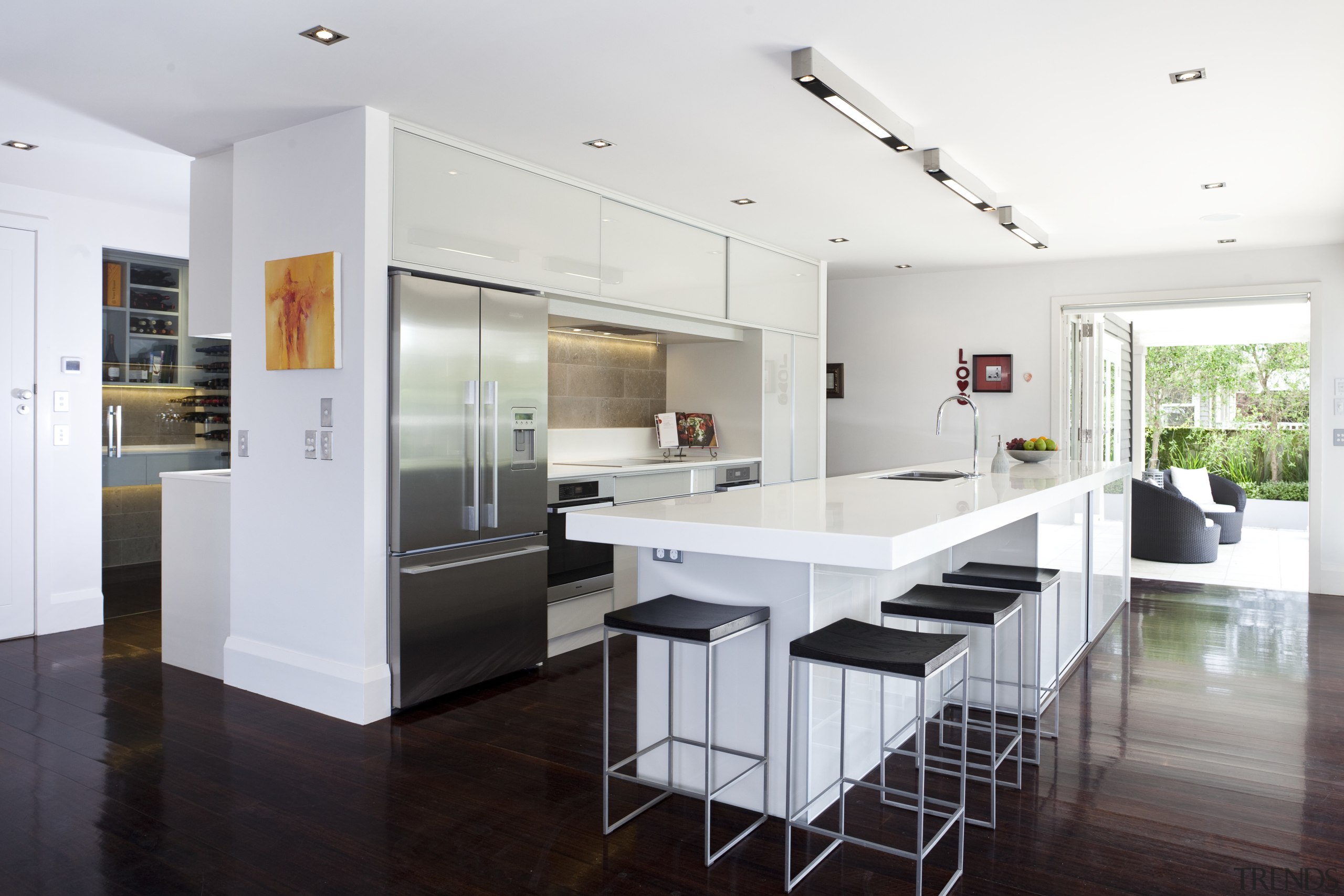 View of contemporary kitchen with white cabinetry, wooden countertop, floor, house, interior design, kitchen, real estate, white