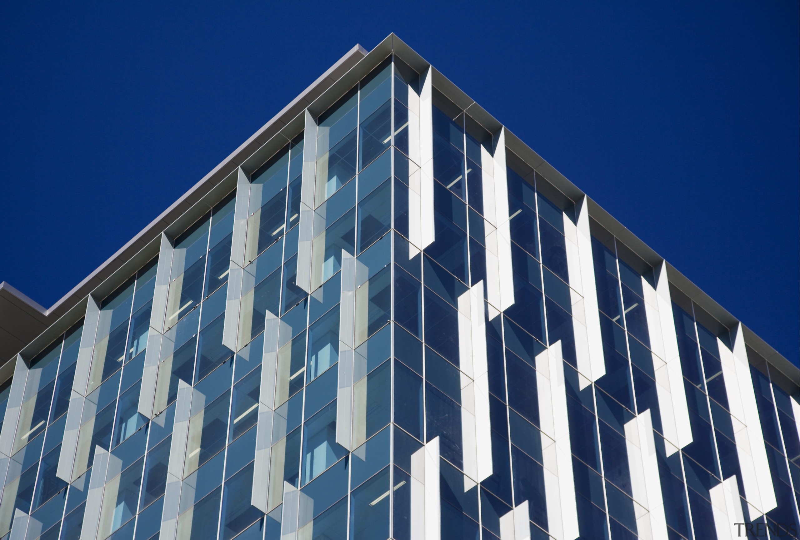 Architectural blades on the window systems combine an architecture, blue, building, commercial building, condominium, corporate headquarters, daylighting, daytime, facade, headquarters, landmark, line, metropolis, metropolitan area, sky, skyscraper, structure, symmetry, tower block, window, blue