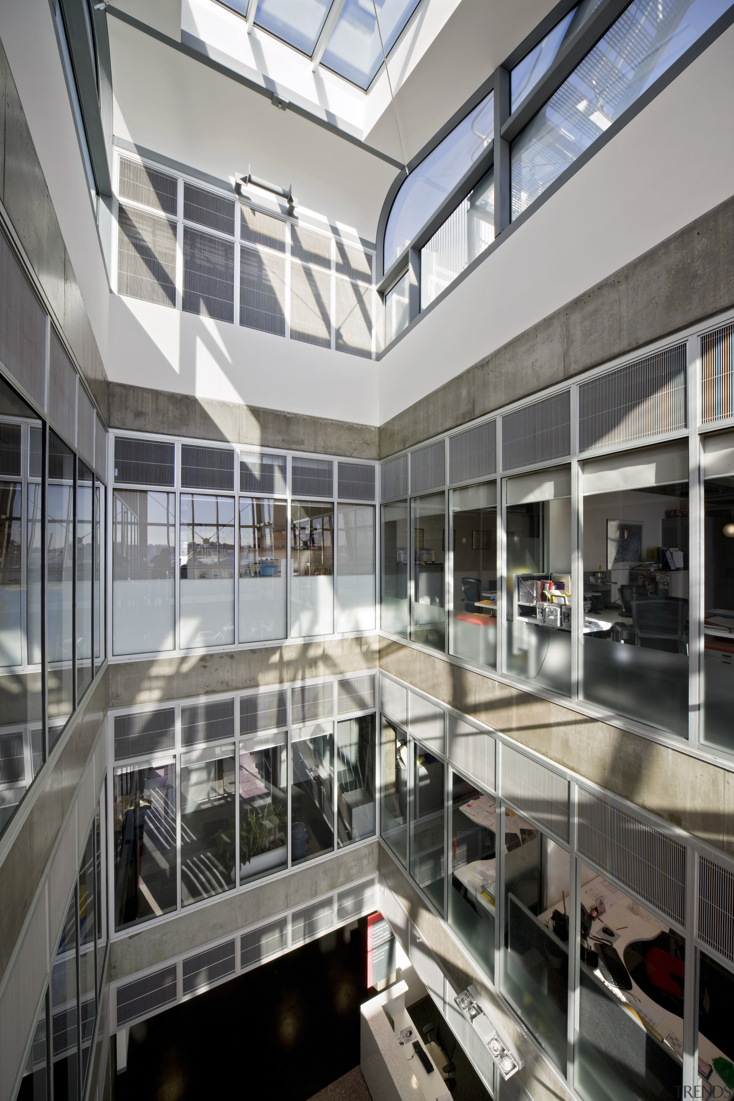 Internal glazing creates a transparency within the building, apartment, architecture, building, corporate headquarters, daylighting, headquarters, metropolitan area, mixed use, gray, black