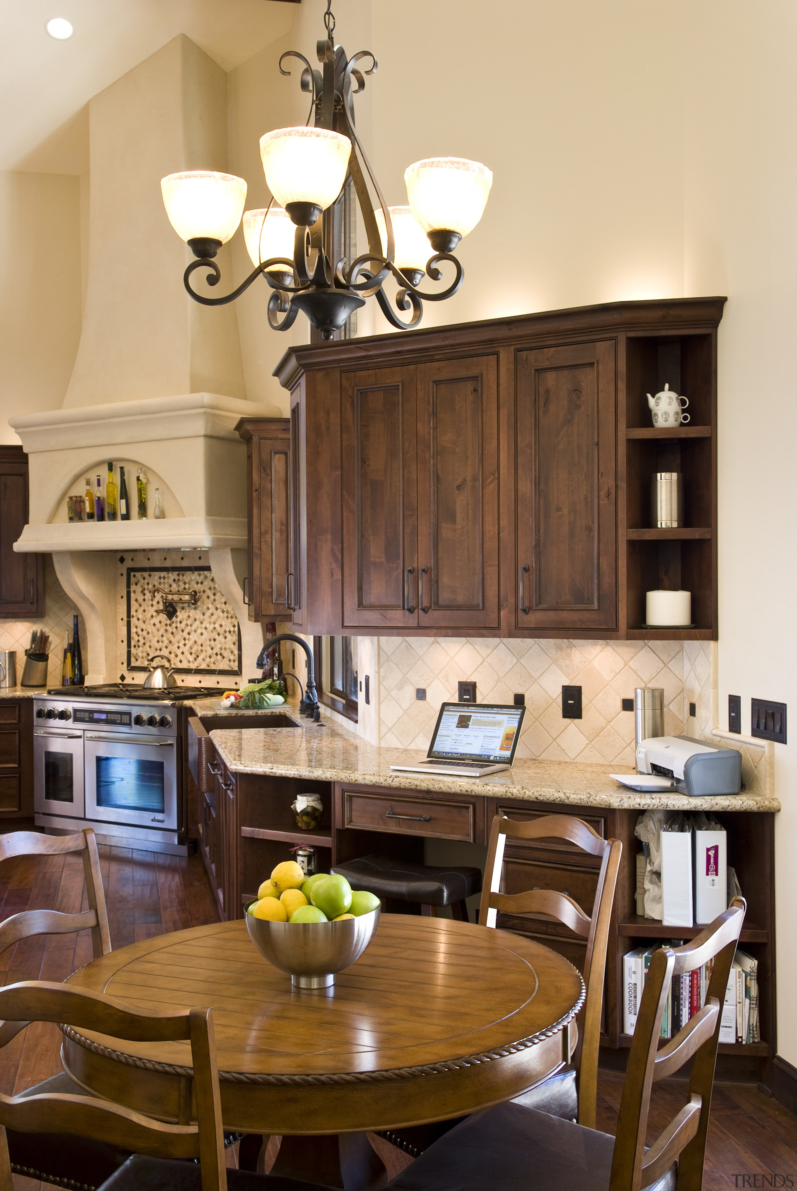 View of a Tuscan-styled kitchen which features dark-stained cabinetry, ceiling, countertop, dining room, furniture, home, interior design, kitchen, living room, room, table, brown, orange