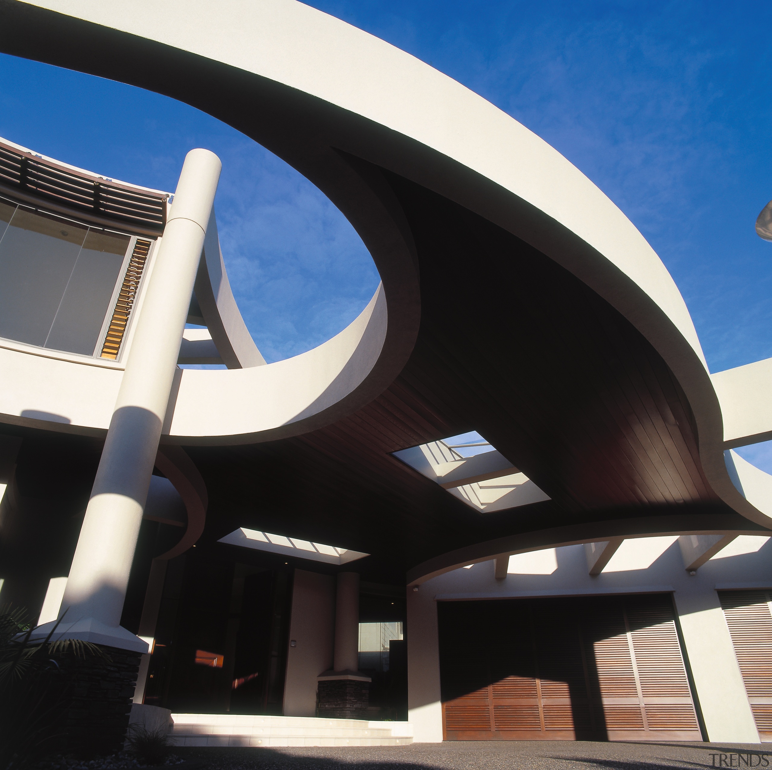 Entranceway of house with sweeping porte cochere with architecture, building, daylighting, daytime, facade, sky, structure, black