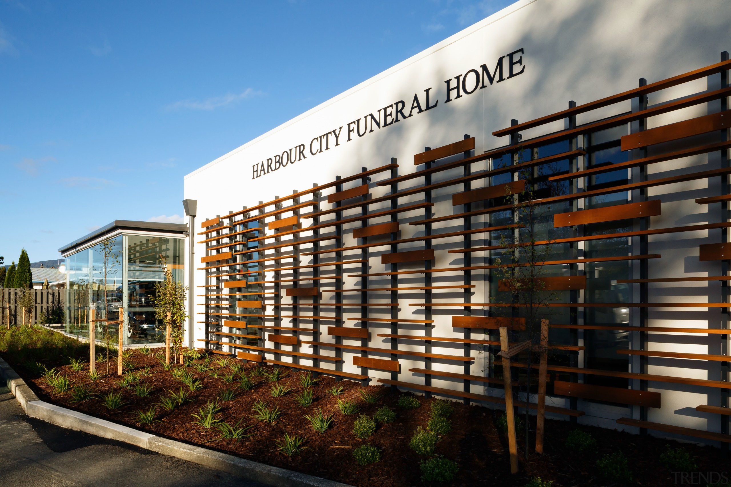 The cedar screen on this new funeral home architecture, building, condominium, corporate headquarters, facade, mixed use, real estate, residential area, sky, black