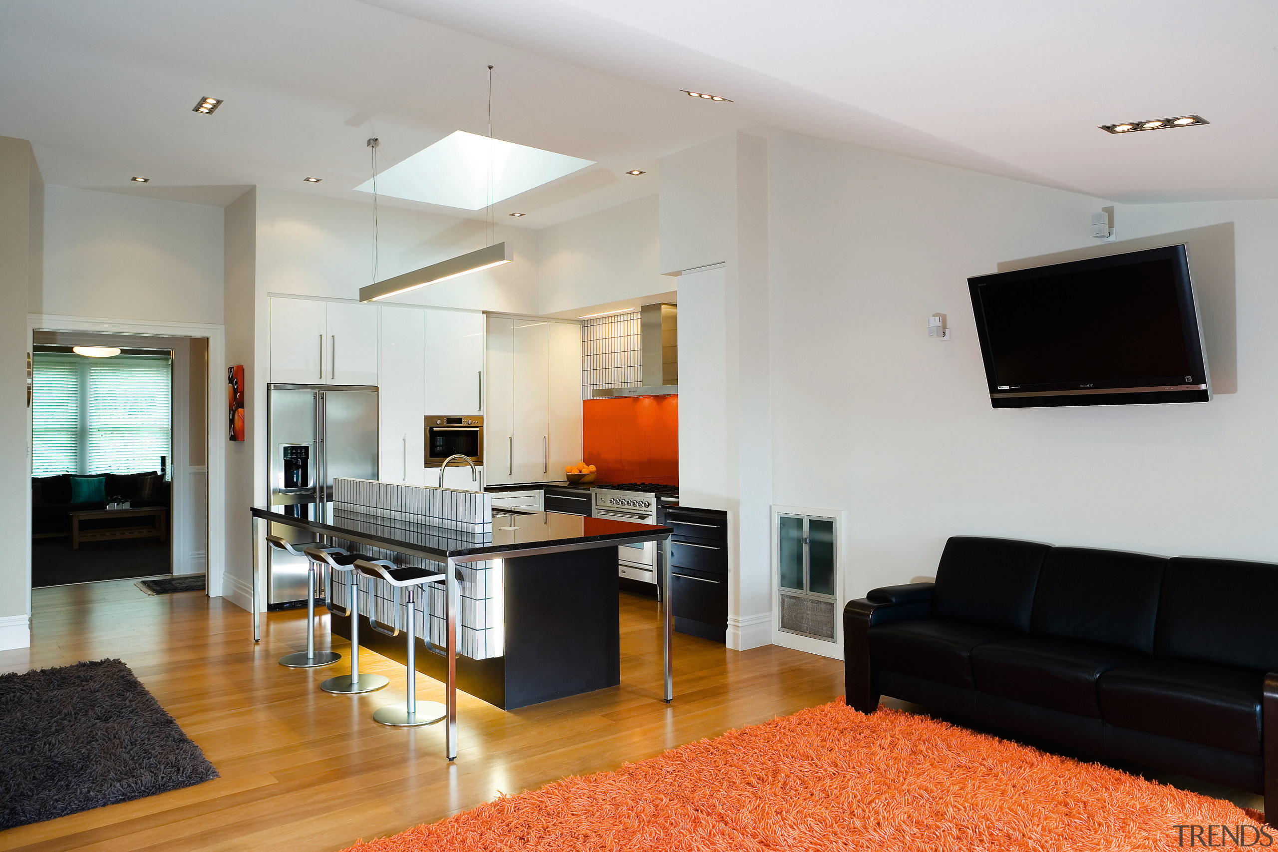 A view of this kitchen featuring kauri flooring, apartment, floor, flooring, house, interior design, living room, real estate, room, gray