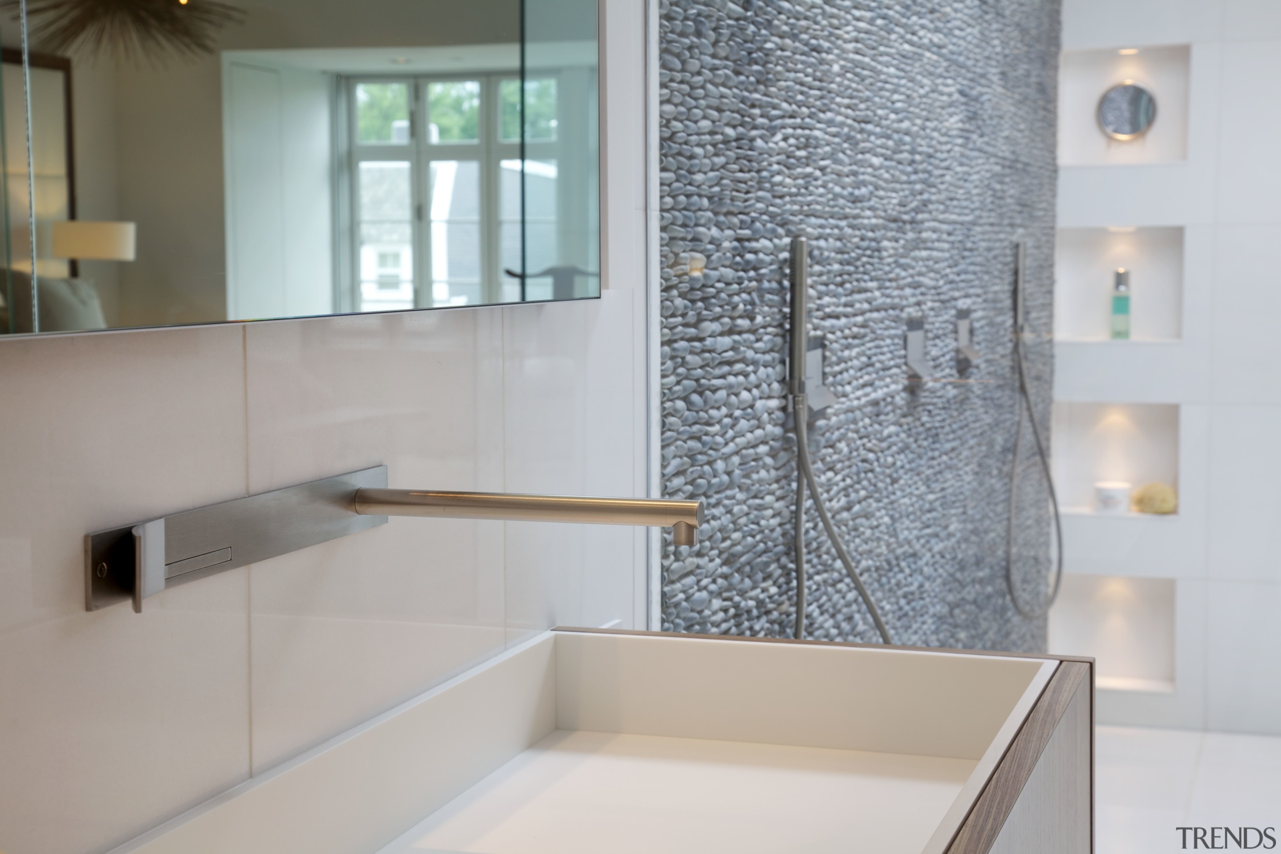 Wall-mounted faucets enhance the streamlined look. architecture, bathroom, floor, flooring, home, interior design, product design, room, sink, tap, tile, gray