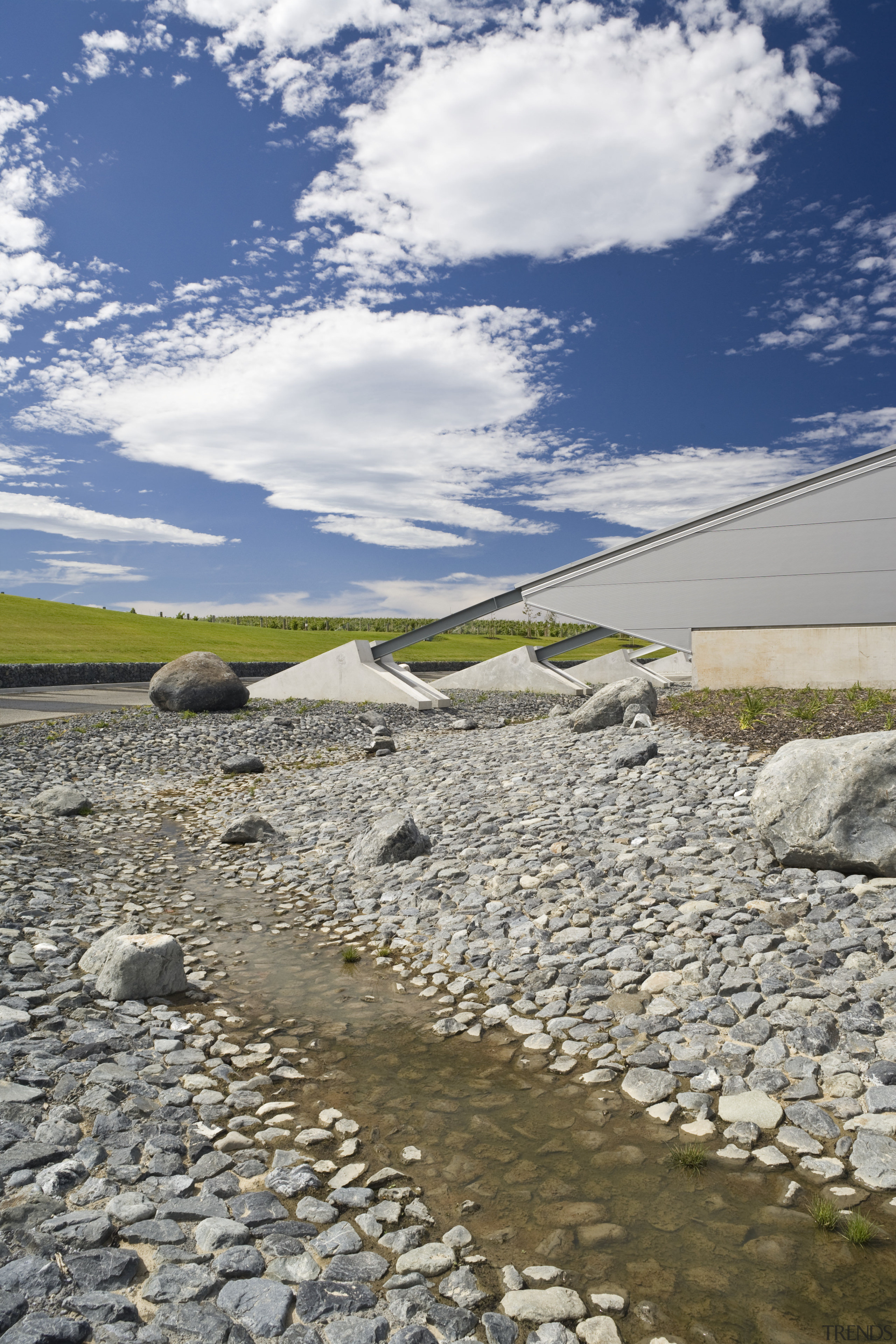 View of Buttresses coming off the side of cloud, field, grass, horizon, landscape, meteorological phenomenon, reservoir, rock, shore, sky, tree, water, gray
