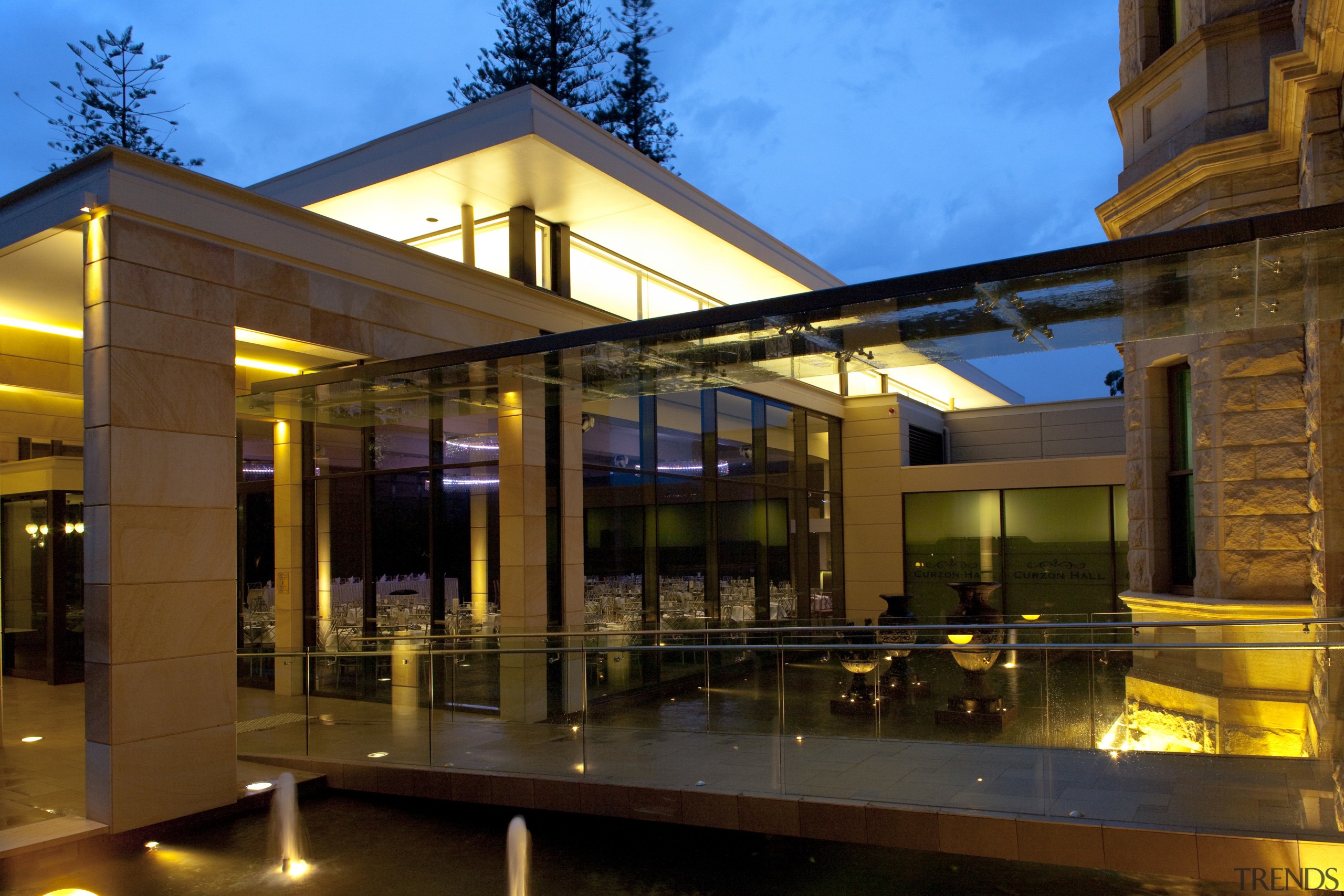 Exterior view of the hall walkway - Exterior apartment, architecture, building, condominium, estate, evening, home, house, lighting, mixed use, night, real estate, reflection, window, brown