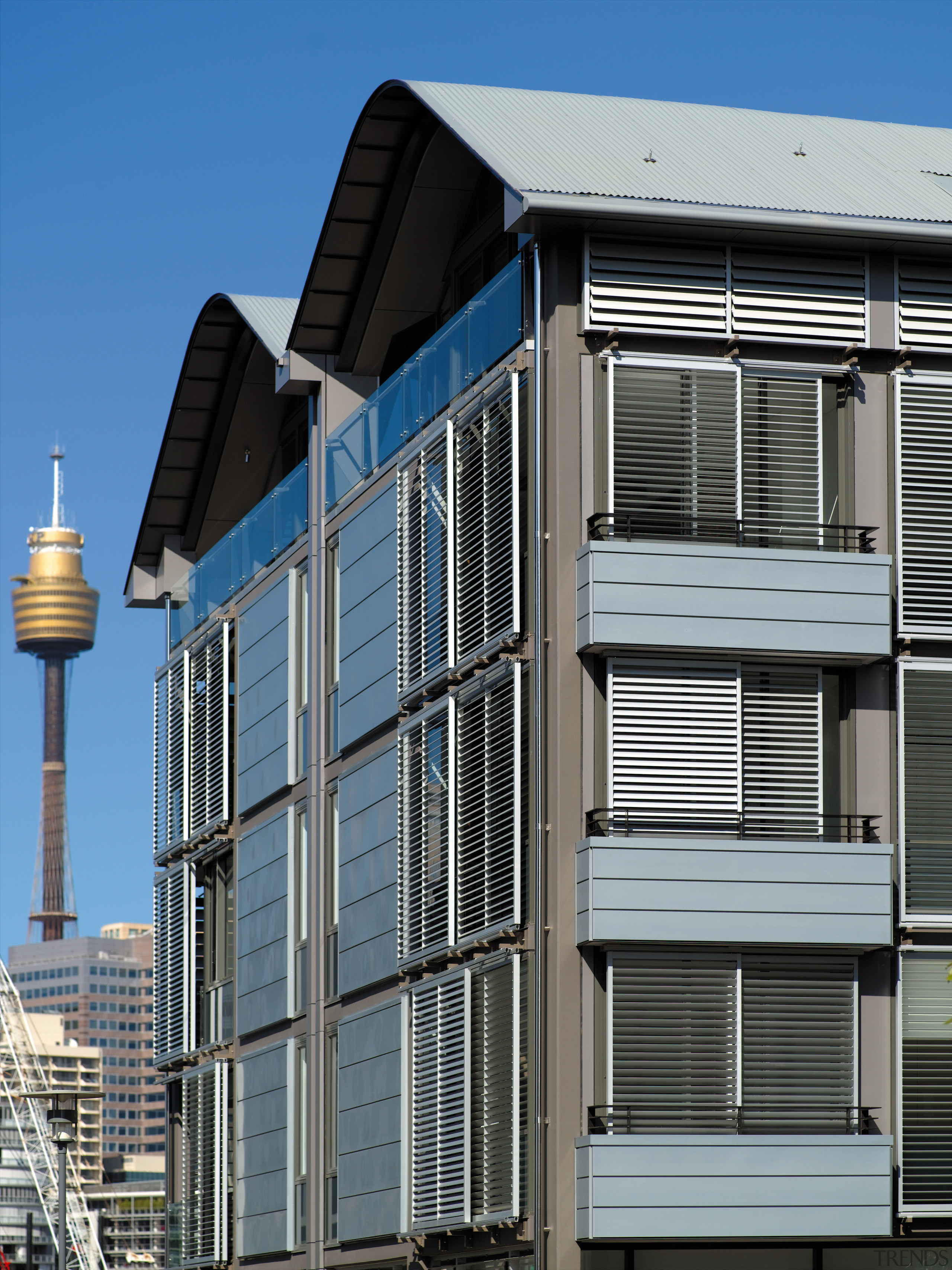 view of the saunders wharf apartments featuring crips architecture, building, city, commercial building, condominium, facade, house, metropolitan area, residential area, structure, urban area, window, gray, black, teal