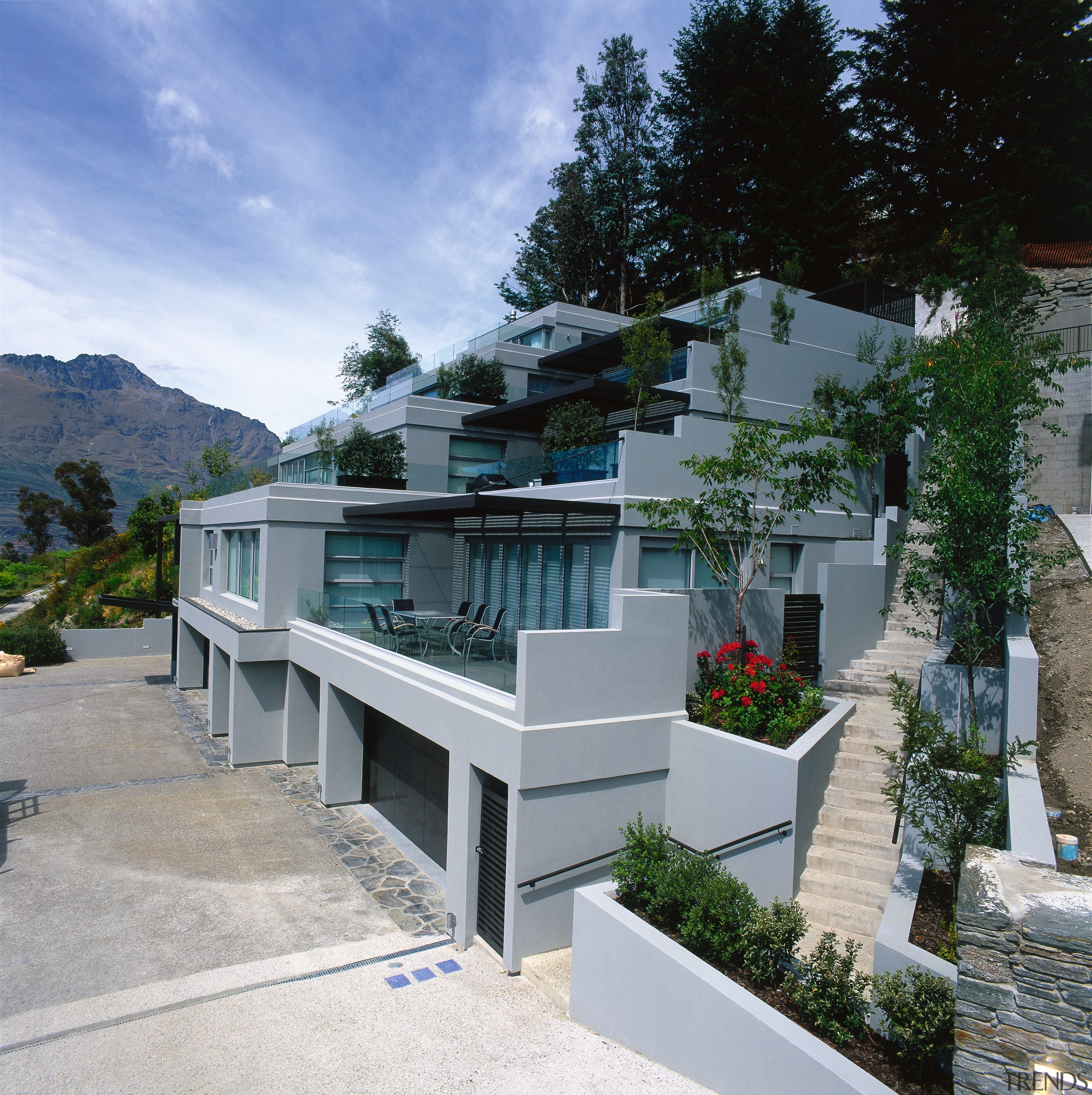 An exterior view of the entire apartment complex. architecture, condominium, facade, house, property, real estate, residential area, villa, gray