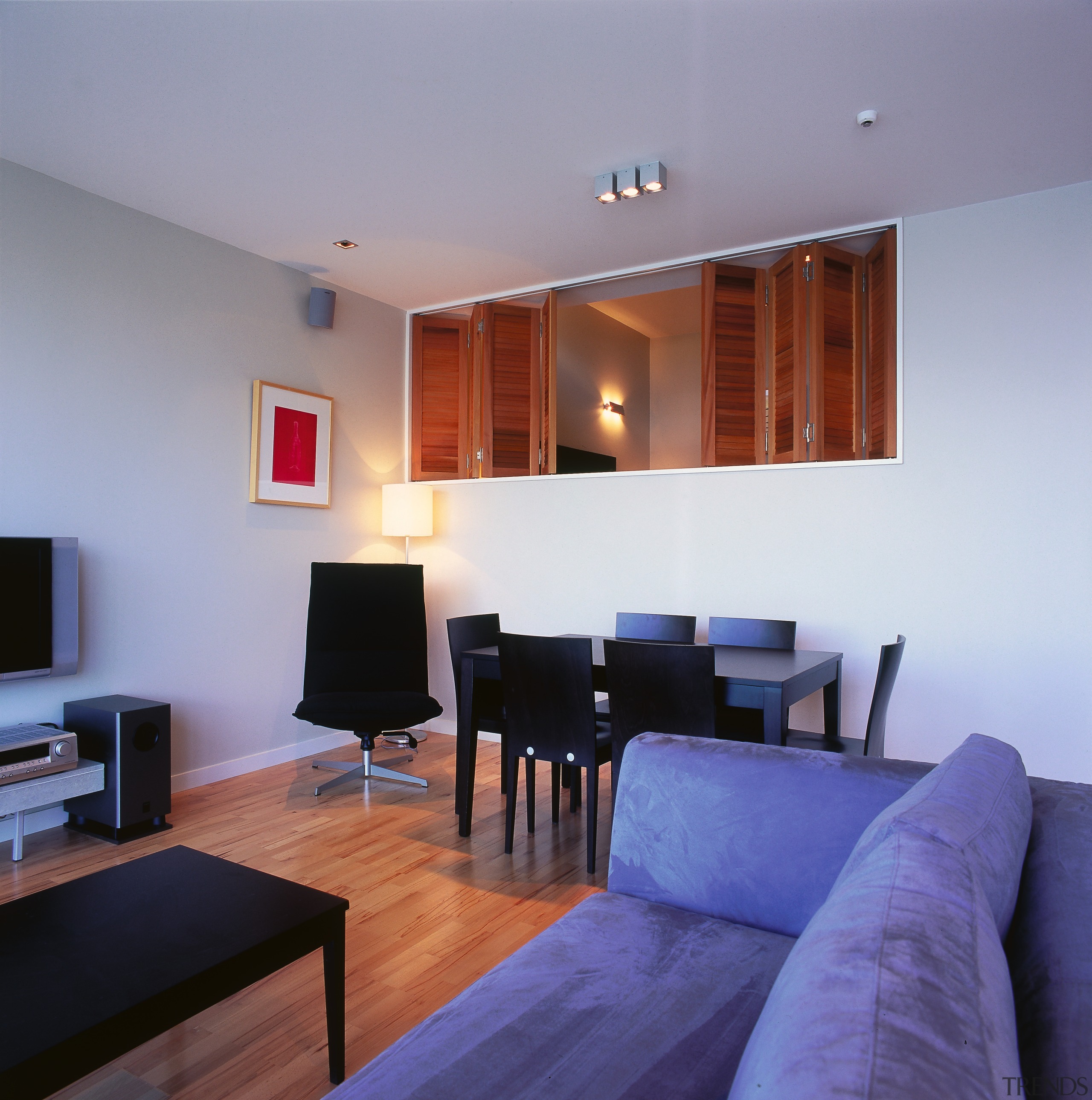 Lounge and dining area with dark furniture, cream apartment, ceiling, floor, flooring, house, interior design, living room, property, real estate, room, suite, gray