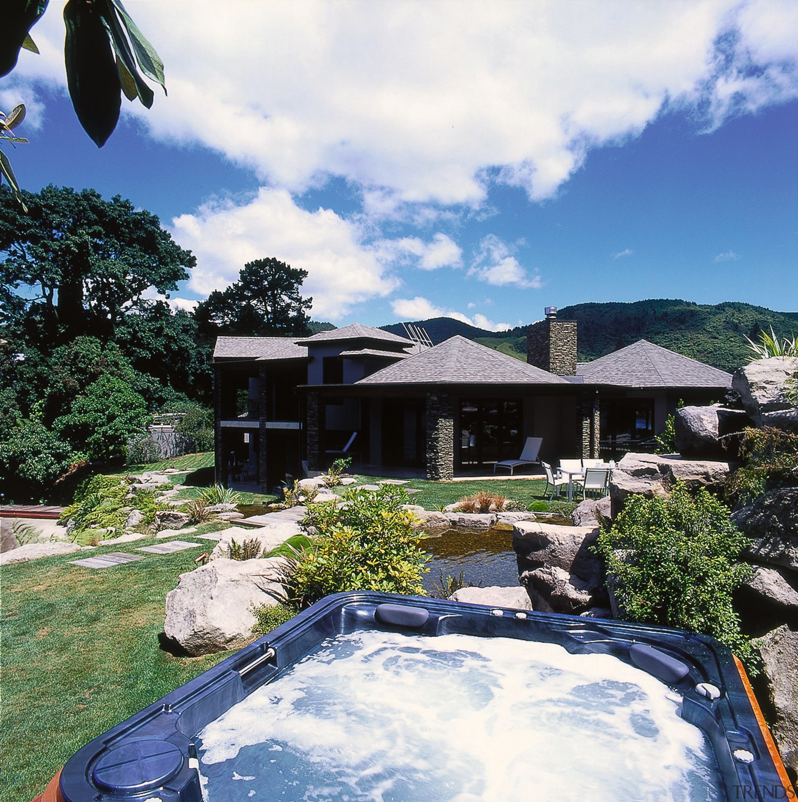 Close view of the spa pool area - backyard, cottage, estate, home, house, landscape, outdoor structure, property, real estate, roof, sky, swimming pool, tree, villa, white