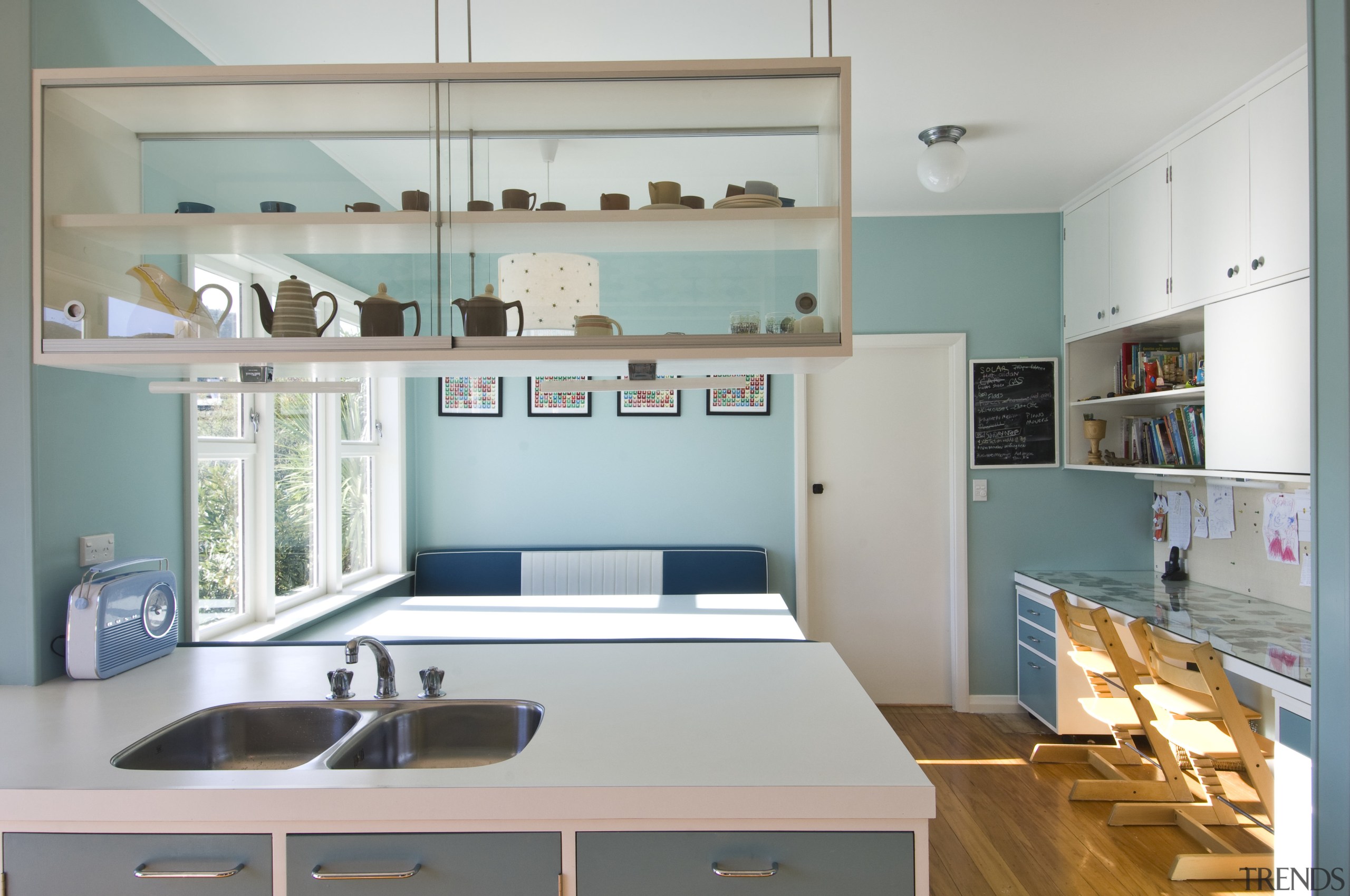 View of a kitchen which features blue cabinetry cabinetry, countertop, interior design, kitchen, room, shelf, shelving, gray