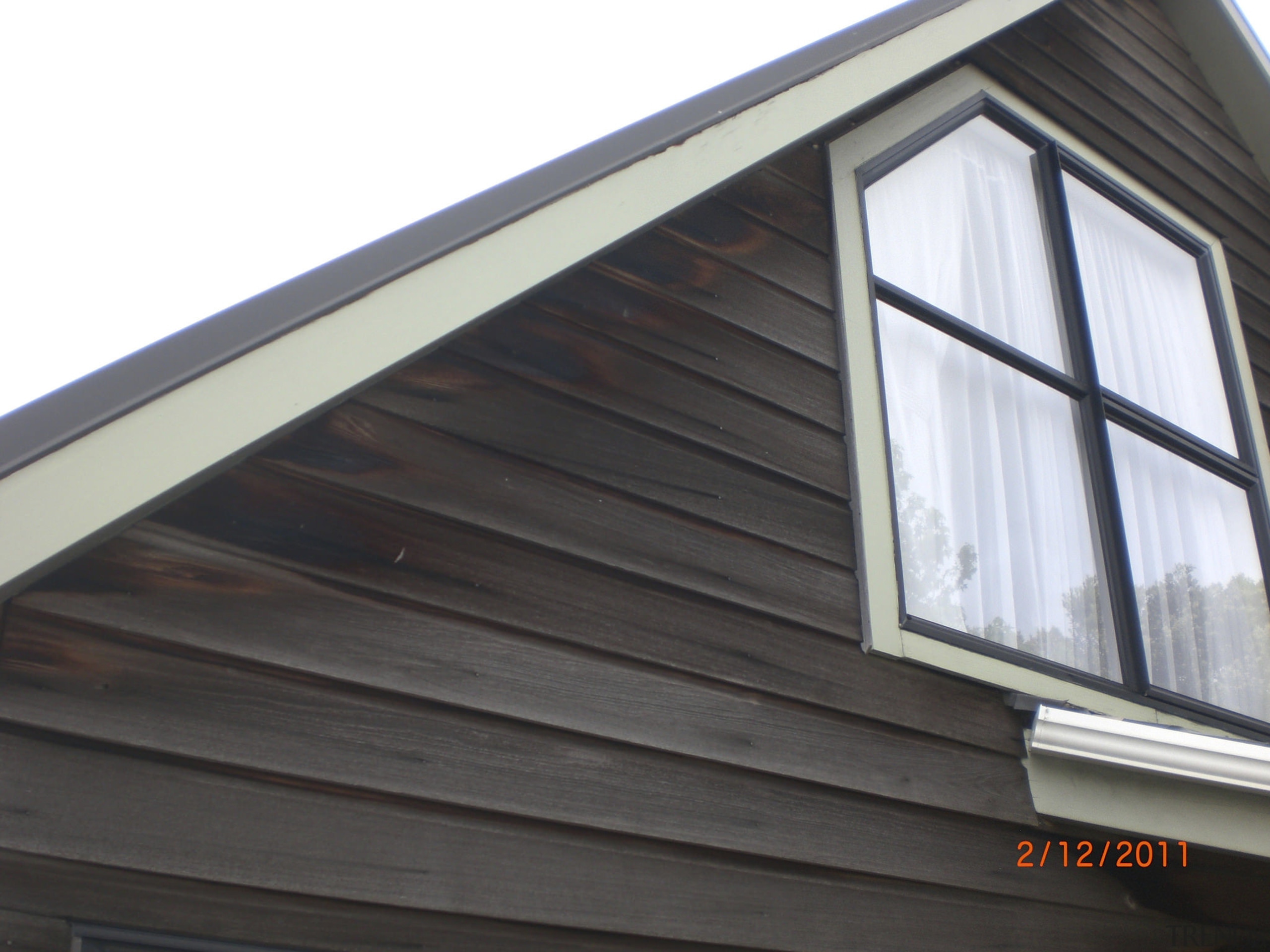Resene Waterborne Woodsman was used on this daylighting, facade, home, roof, siding, window, black, white